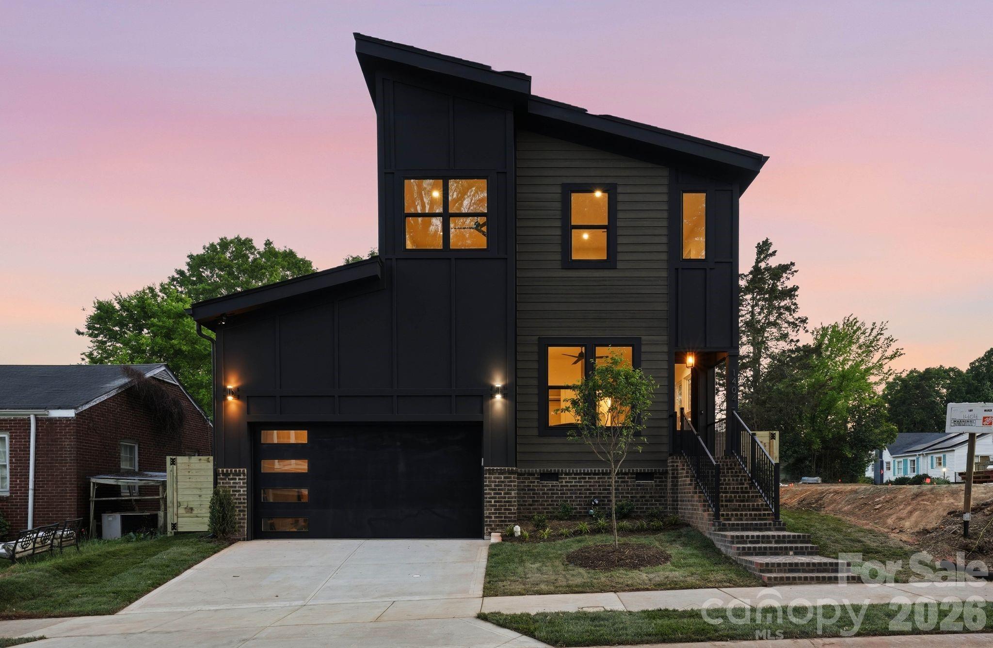 Located just minutes from Plaza Midwood and NoDa, this thoughtfully designed new construction property offers a rare opportunity to own a turnkey residence in one of Charlotte’s most vibrant areas. Blending elevated finishes with a highly livable layout, the main level begins with a versatile office or guest suite and a full bath, ideal for visitors or working from home. The space then opens into a bright, open-concept living area where the kitchen, dining, and living rooms flow seamlessly together. Large openings off the living room lead directly to a covered rear patio, creating an effortless connection to the outdoors and a spacious, fully fenced backyard designed for privacy, entertaining, and everyday enjoyment. The kitchen is a true focal point, featuring custom cabinetry, quartz surfaces, high-end appliances, a walk-in pantry, and a beautifully appointed wet bar. An oversized two-car garage with 14-foot ceilings adds both function and volume, with a well-appointed drop zone featuring custom built-ins and a pet feeding station creating a seamless transition into the home.Upstairs, the primary suite serves as a private retreat with a spa-inspired bath and a custom walk-in closet. Three additional bedrooms offer flexibility for guests, family, or additional workspace, complemented by a well-appointed hall bath and a dedicated laundry room. Every detail reflects a focus on quality, from the hardwood floors and designer lighting to the seamless, built-in storage throughout.Situated in the Plaza area, this home offers quick access to Plaza Midwood, NoDa, and Uptown Charlotte, with seamless connectivity to I-74 and other major roadways for easy commuting. Enjoy close proximity to the city’s top dining, retail, and everyday conveniences, along with access to highly regarded schools. This stunning residence represents a rare blend of new construction, elevated design, and one of Charlotte’s most dynamic and rapidly evolving locations.