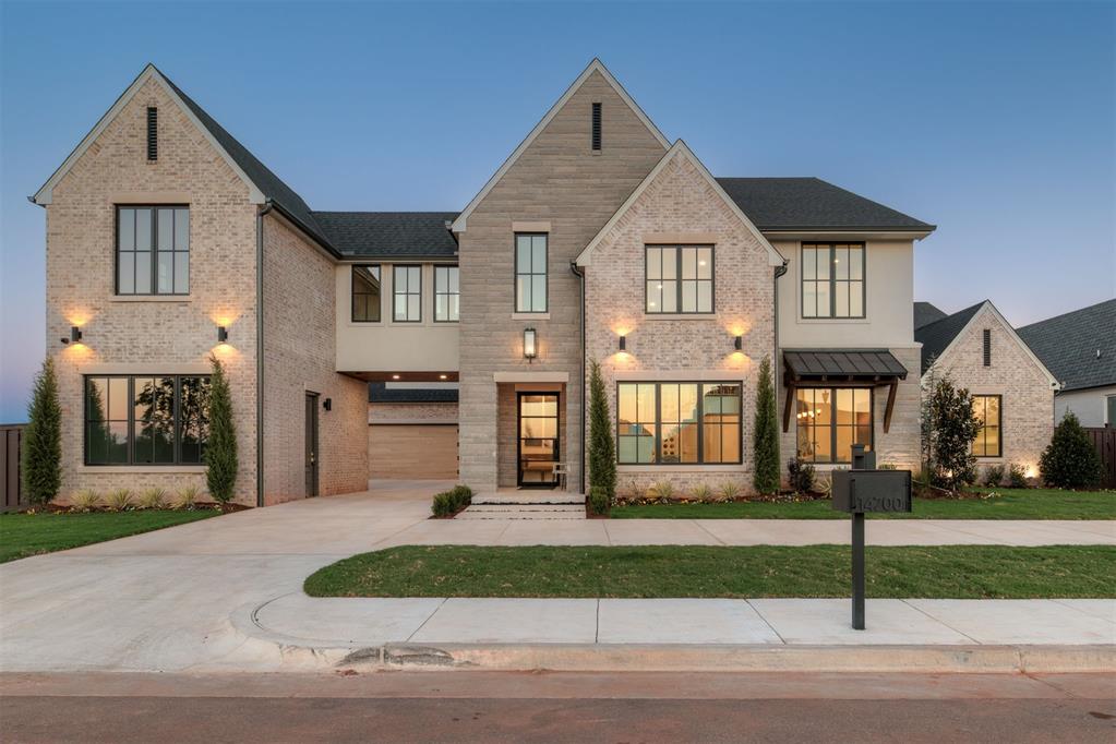 Don’t miss this brand new one of a kind, 5 bedroom, 6 bath home located in NW OKC’s prestigious Manors of Annecy gated community. This stunning custom home blends timeless luxury with modern design. Upon entering you’ll be welcomed with a soaring floating staircase accented by floor to ceiling windows in the backdrop & a custom marble fountain located at the base of the stairs. Adjacent to the entry you’ll also find a wine area featuring a Dacor wine dispenser & undercounter wine fridge great for entertaining guest! This home boasts a study & 2 large eating areas, the formal dining room connected by a butlers pantry, sink, speed oven & large walk in pantry as well. The main living area with its expansive 2-story great room, French oak wood floors, gas fireplace, kitchen, and dinette filled with natural light. Chefs delight cooking on GE monogram 48” gas range & paneled fridge/freezer/dishwasher & workstation sink. Step out of your living room sliding doors to a spacious backyard covered patio, outdoor fireplace, grill & entertaining area with stunning pool & hot tub. The main floors suite details coffee bar & gas fireplace with sunny reading nook & bench seat. Wet room & large primary shower, 2 shower heads & soaking tub, his/her vanities and a huge walk-in closet, situated next to the laundry room for added privacy. Upstairs level features 3 bedrooms all with en-suite baths and walk-in closets. Large game room & second floor laundry/craft room as well. What makes this gorgeous home completely unique is the homes back staircase leading to a separate “guest apartment” above the 2-car garage. Perfect for guest, nanny, college age students, this 576 sq. ft. apartment includes a full kitchen, bathroom, bedroom and family room. A separate 1-car garage provides additional storage and parking.
