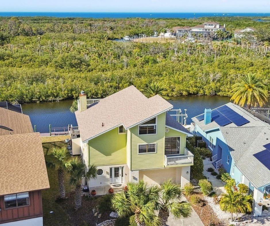**New Price** Seller very motivated** One or more photo(s) has been virtually staged. Possibly the Best Open Gulf View in Gulf Harbors — Priced Below Comparable Waterfront Homes.Positioned on one of the premier waterfront homesites in Gulf Harbors, this exceptional coastal residence offers what many consider to be one of the finest unobstructed Gulf views in the entire community. Combining luxury waterfront living with outstanding value, this elevated retreat presents a rare opportunity to own a move-in-ready Gulf-front lifestyle at a price that compares favorably to many waterfront homes with less impressive views.Situated approximately 14 feet above sea level, the home was thoughtfully designed to maximize both panoramic water views and peace of mind. Whether enjoying your morning coffee or watching spectacular sunsets paint the sky each evening, nearly every outdoor living space showcases breathtaking vistas of the Gulf.Meticulously maintained and extensively updated, the property features a new roof (January 2025), new HVAC system (2022), hot water heater (2018), and a 10,000-pound electric boat lift (2018), making it an ideal retreat for boating enthusiasts. Durable Hardie board siding, beautifully renovated bathrooms, and multiple outdoor entertaining areas enhance the home's coastal charm and functionality. Covered balconies, screened porches, open-air decks, and waterfront gathering spaces provide endless opportunities to entertain family and friends or simply relax and enjoy the tranquil surroundings.The main living level features an expansive great room with soaring 17-foot vaulted ceilings, a wood-burning fireplace, and walls of windows that capture stunning water views from nearly every angle. The spacious kitchen is appointed with rich wood cabinetry, granite countertops, and a seamless connection to the breakfast area and waterfront balcony, creating the perfect setting for indoor-outdoor living.Three bedrooms offer direct access to outdoor decks, including two with private balconies. A versatile fourth bedroom or bonus room is connected by a charming walkway to a private third-floor balcony, providing additional flexibility for guests, a home office, or hobby space.Step outside to the expansive waterfront deck where dolphins, manatees, and unforgettable sunsets become part of your daily routine. Located within the highly sought-after Gulf Harbors community, residents enjoy access to a private boat ramp, floating dock, clubhouse, tennis courts, pool, spa, and membership opportunities at the exclusive Gulf Harbors Private Beach Club.Just minutes from waterfront dining, shopping, entertainment, and Gulf Coast attractions, this remarkable property offers a combination of open Gulf views, boating access, elevation, updates, and value that is rarely available in today's market. If you've been searching for a waterfront home that delivers exceptional views, coastal lifestyle, and outstanding value, 6321 Garland Court deserves your attention.
