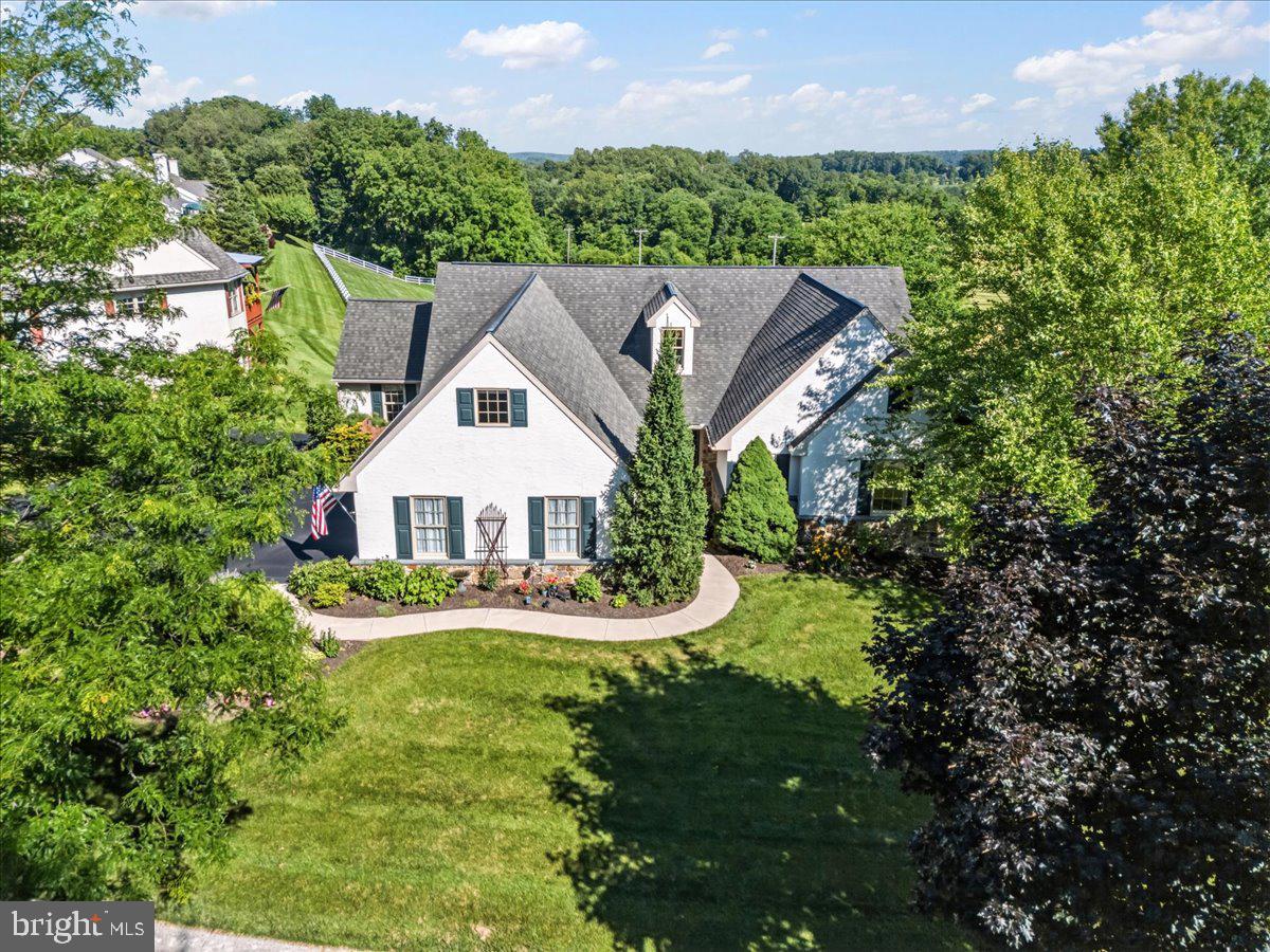 This beautifully updated single-family home in the desirable Summerfield at Elverson community offers effortless single-floor living with exceptional upgrades throughout. The master suite is a true retreat, featuring rich hardwood floors in the bedroom and an extensively renovated master bathroom. The spa-like bath includes a custom shower with elegant marble walls, a dual-head shower system, a built-in seat, and tiled flooring, along with a new vanity, dual sinks, updated faucets, new lighting, heated floors, a convenient pocket door, and a replaced bathroom window.Two impressive additions enhance the living space. A bright sunroom features multiple skylights, a ceiling fan, and gorgeous views, making it the perfect spot to relax. A cozy side den offers a gas fireplace with a stone hearth and handsome walnut mantle, new hardwood floors, custom lighting, and beautiful Anderson windows.The massive kitchen renovation is a standout, complete with sleek quartz countertops, a large island with matching quartz, a stylish tile backsplash, and durable new Armstrong Core-Tex flooring. All new black stainless steel appliances complete the space, while the adjacent breakfast area features hardwood floors and newly replaced windows.Major systems have all been thoughtfully addressed, including a brand new roof installed in June 2026, a geothermal heating and cooling system added in 2023 with an additional pre-heat hot water tank, a hot water heater replaced in 2018, and a driveway that was milled and repaved in 2022 and seal coated in 2024.Enjoy true maintenance-free living in this lovely community. The low annual HOA dues of just $1,675 cover professional lawn mowing, fertilizing, weed treatment, and snow removal up to the garage door.This move-in ready home perfectly combines modern luxury, thoughtful updates, and carefree living in the sought-after Summerfield at Elverson community.