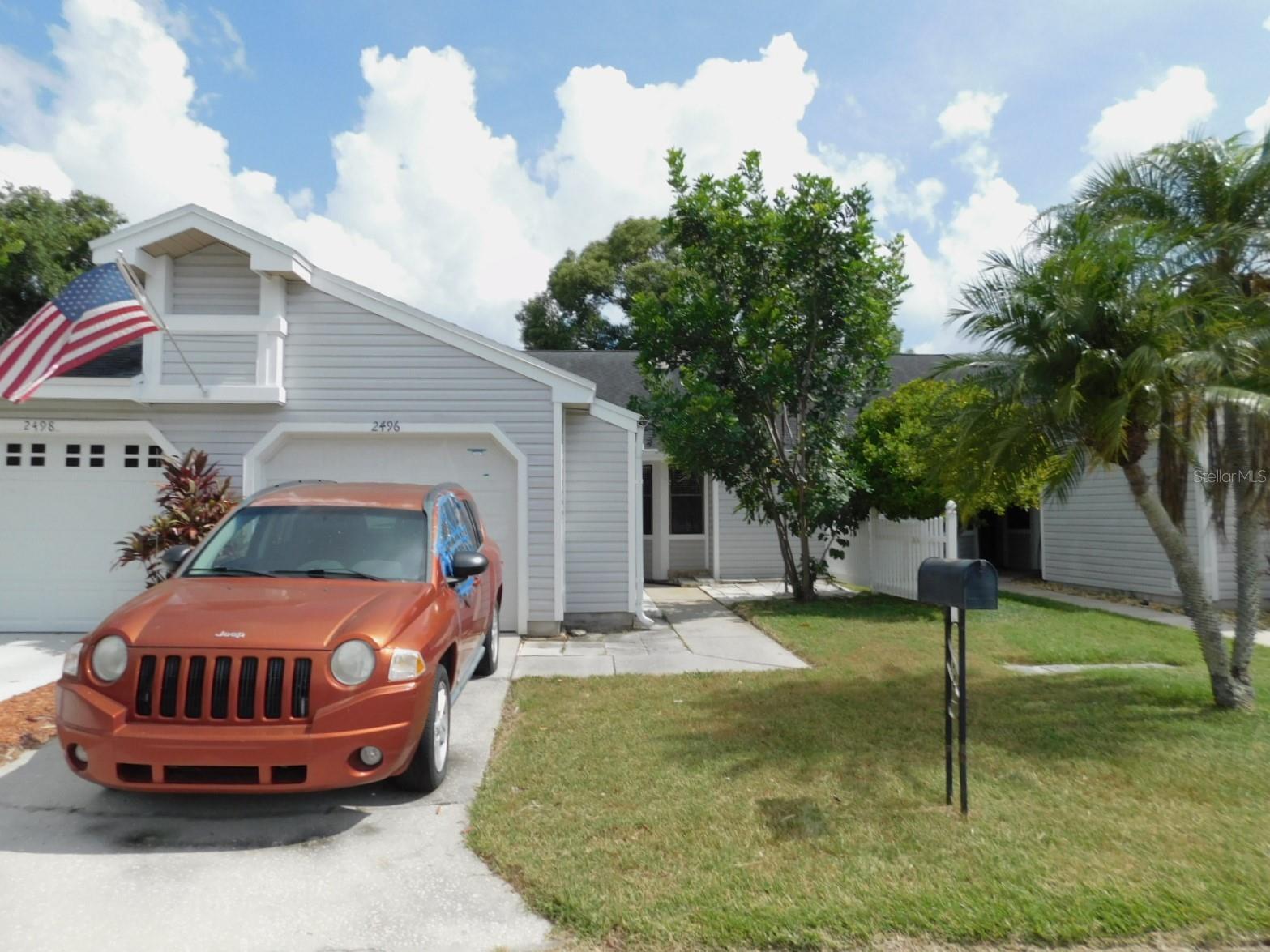 This 2-bedroom, 2-bath home offers a spacious living room with high ceilings, a functional kitchen with ample cabinet space and room for a breakfast nook, plus an enclosed patio overlooking the backyard.  Large primary bedroom with sliders to the patio, a spacious walk-in closet and attached bathroom with walk-in shower.   Attached garage with plenty of guest parking. Great Clearwater location close to shops, dining, and easy access to US 19.  This one is ready for updates and being Sold As Is. There is a gated yard