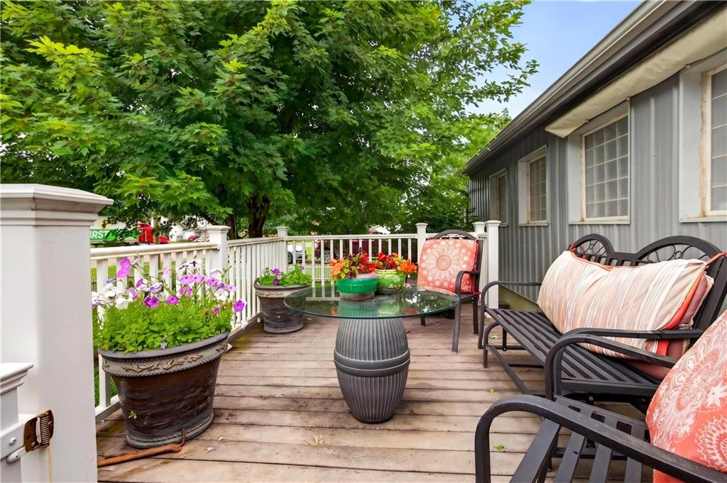 Located on almost 1/2 acre, you'll love this updated slab-built home with nearly 3400 square feet of living space, surrounded by white vinyl picket fencing at the entry, adding charm & beauty. Enjoy the afternoon on the composite deck with no worries of the hot sun. The electric retractable awning located on the front & back patio areas provides the perfect shade on a warm day.  Fruit trees, blooming flowers & ornamental grasses surround the home, along with the perfect raised strawberry bed. Created with efficiency & low maintenance in mind, yet finished with attractive features, the flexible layout of the home provides opportunities for use in multiple ways such as an individual home, or multi-family living &/or a home business. Feel pampered in 2 separate master suites as you prepare for your day, each having attached zero entry spa-like showers, large dressing areas, double vanities and enough space to create additional bedrooms, if desired. A large walk-in closet in the 2nd primary bedroom doubles as a saferoom to provide peace of mind during storms. This home has been modernized with stained concrete & vinyl plank flooring, as well as thermal windows that allow privacy & wonderful natural light to flow throughout. Several doorways are accented with barn-type slider doors &/or French door entries to provide appeal. Get creative in the spacious kitchen making use of the abundant counter space & cabinetry featuring an open pass-through leading to a coffee bar & relaxed dining area. The design allows for meal prep & dining to be enjoyed while entertaining. Looking for a workshop space? Look no further! An attached 15x8 workshop is located west of the carport, as well as a 3 car detached garage with concrete floor, elec amp's for welding, storage & more. At the end of the day, stroll down to the firepit/patio swing area for an evening of smores & enjoy the relaxing sounds of birds singing in the evening air.  This home is truly a must see!