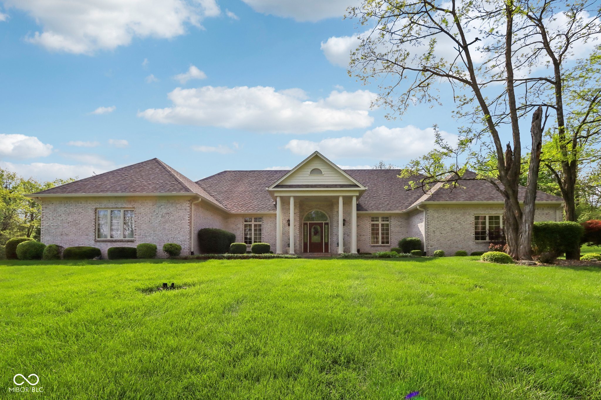 Welcome to this beautifully crafted 4-bedroom, 3.5-bathroom all-brick ranch offering a rare combination of privacy, luxury, and functionality-all on over 2 acres with mature trees and a tranquil private pond. This home features a thoughtfully designed one-level floor plan with a fully finished walk-out basement, perfect for entertaining or multi-generational living. The expansive primary suite is a true retreat, boasting a cozy fireplace, en suite bathroom, and generous space for a sitting area or office nook. Additionally, you'll find an open-concept layout with abundant natural light, a dedicated exercise room, and multiple living spaces ideal for both everyday living and gatherings. The oversized 3-car attached garage on the main level is complemented by an additional garage in the basement, providing exceptional storage or workshop space. Outdoor living is truly exceptional here. Step out to a screened-in porch that opens to a stamped concrete patio complete with a pergola-perfect for relaxing or hosting guests. The in-ground pool creates a resort-like feel, while the separate pool house adds incredible value with its full kitchen, laundry, and full bathroom-ideal for summer entertaining or guest accommodations. Surrounded by mature landscaping and nature views, this one-of-a-kind property offers peace and privacy with all the conveniences just a short drive away.
