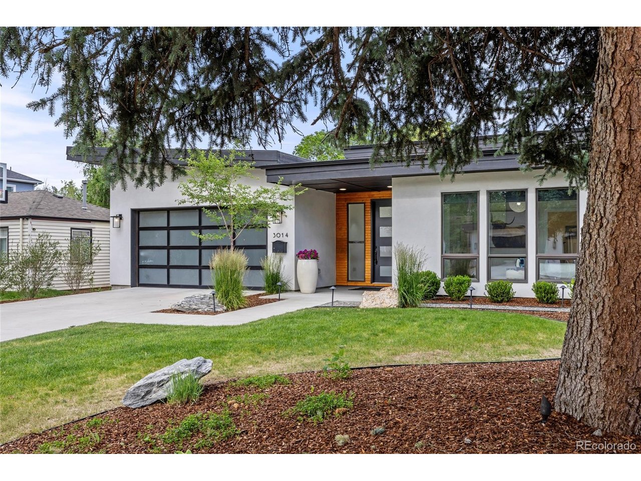 Highly sought-after 5-bedroom, 5-bathroom Mid-Century Modern ranch offering 4,832 square feet in University Hills, just steps from Eisenhower Park, featuring iconic clerestory windows that flood the home with natural light and enhance its timeless architectural appeal. Enjoy your own private backyard oasis, with a heated in-ground swimming pool, relaxing in-ground hot tub and low-maintenance turf yard. The inviting patio living area is anchored by a stunning outdoor/indoor fireplace that creates a lounge-like atmosphere for alfresco gatherings and year-round entertaining. The chef's kitchen is an entertainer's dream, showcasing waterfall countertops, premium Thermador appliances including a 30-inch refrigerator, 30-inch freezer, built-in wine refrigerator, integrated barista station, 48-inch range with steam oven, warming drawer, and drawer microwave; all thoughtfully flowing into the open living room space. The main-floor primary suite is privately located on the North side of the home, overlooks the calming pool and backyard, offers automated window coverings, an equipped custom Colorado Closets walk-in closet, and a spa-inspired five-piece bath complete with a Japanese bidet. The finished full basement provides expansive living and recreation space ideal for family hang out space and entertaining, complete with a bar and beverage refrigerator, microwave, included television and three storage areas.This exceptional Mid-Century Modern home combines timeless architecture, luxury amenities, and an unbeatable location in one of Denver's most desirable neighborhoods.