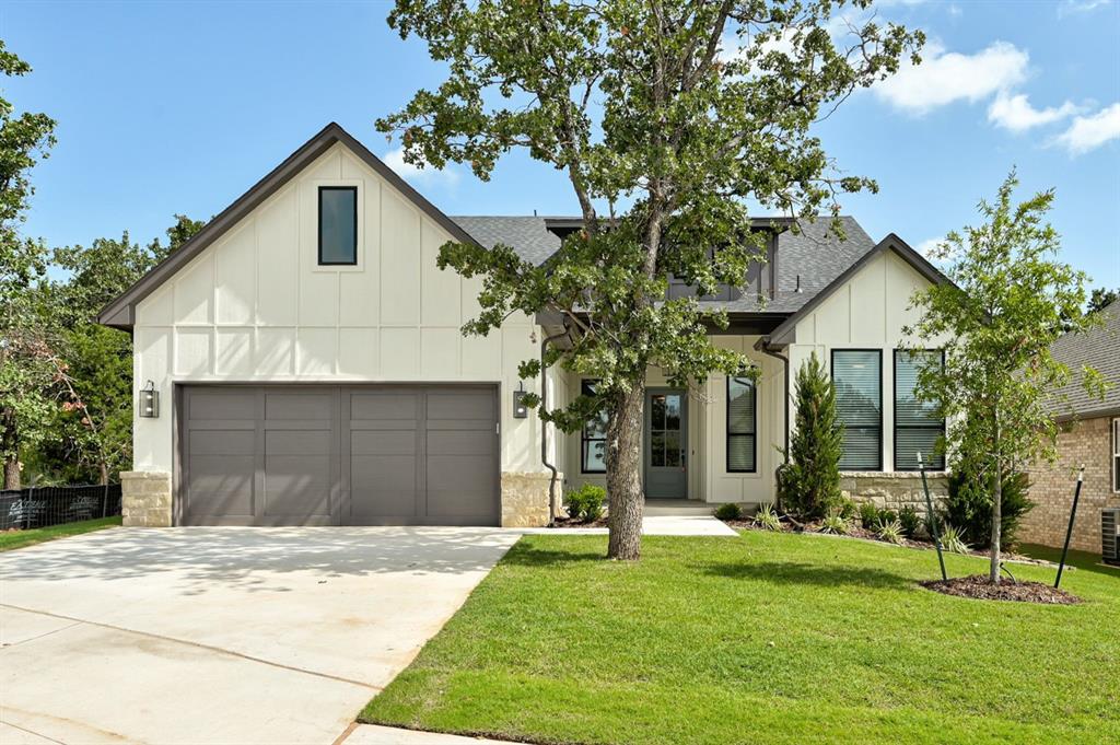 The warm and inviting Hickory plan perfectly blends farmhouse inspired charm with contemporary luxury, ideally situated within Edmond’s premier gated community of Cross Timbers. This home offers the added benefit of full, year round lawn maintenance, providing a truly low maintenance living experience. From the moment you enter, engineered wood flooring flows throughout the main living areas, leading into a spacious L shaped kitchen designed to impress. The kitchen features ceiling height maple cabinetry with glass accented uppers, elegant under cabinet lighting, and timeless hardware, creating a refined yet welcoming atmosphere. Open sightlines connect the kitchen to the main living spaces, where soaring ten to eleven foot ceilings and eight foot doors enhance the sense of openness. The living room is highlighted by beautiful ceiling beams framing a thoughtfully designed gas fireplace, making it an ideal space to relax or entertain. The private primary suite offers a serene retreat, complete with generous space and a spa inspired bathroom featuring a freestanding soaking tub, a walk in shower, and a large primary closet conveniently connected to the utility room for everyday ease. On the opposite side of the home, two spacious secondary bedrooms are positioned alongside a well appointed hall bath with a tub and shower combination accented by a floor to ceiling tile surround. Designer selected finishes throughout, along with a full sprinkler system, blinds, and fencing, complete this beautifully crafted home. This exceptional property delivers comfort, style, and convenience in one of Edmond’s most desirable gated communities.