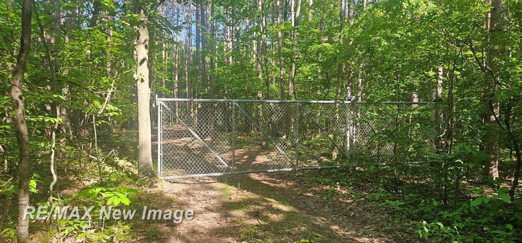 A 10 on 10 Mile!  Welcome to your ultimate outdoor escape-40 acres of thick, beautiful hardwoods located in desirable Midland County. Whether you're looking to build your dream home in a private, wooded setting or want a ready-to-enjoy recreational and hunting property, this land has it all. The acreage features three elevated hunting blinds, established trails, and clearings already in place for food plots, making it ideal for hunters and nature lovers alike.   A newly built 12x24 insulated cabin is wired and ready to run off a generator, offering comfortable shelter in any season. There's also a composite outhouse, a 10x20 barn for storage, and a collection of outdoor equipment including a four-wheeler, riding mower, and two-seater go-kart-all available to be included for immediate enjoyment.  This is a rare opportunity to own a private and well-equipped slice of Michigan wilderness, with everything you need already in place for hunting, camping, or simply escaping the everyday.