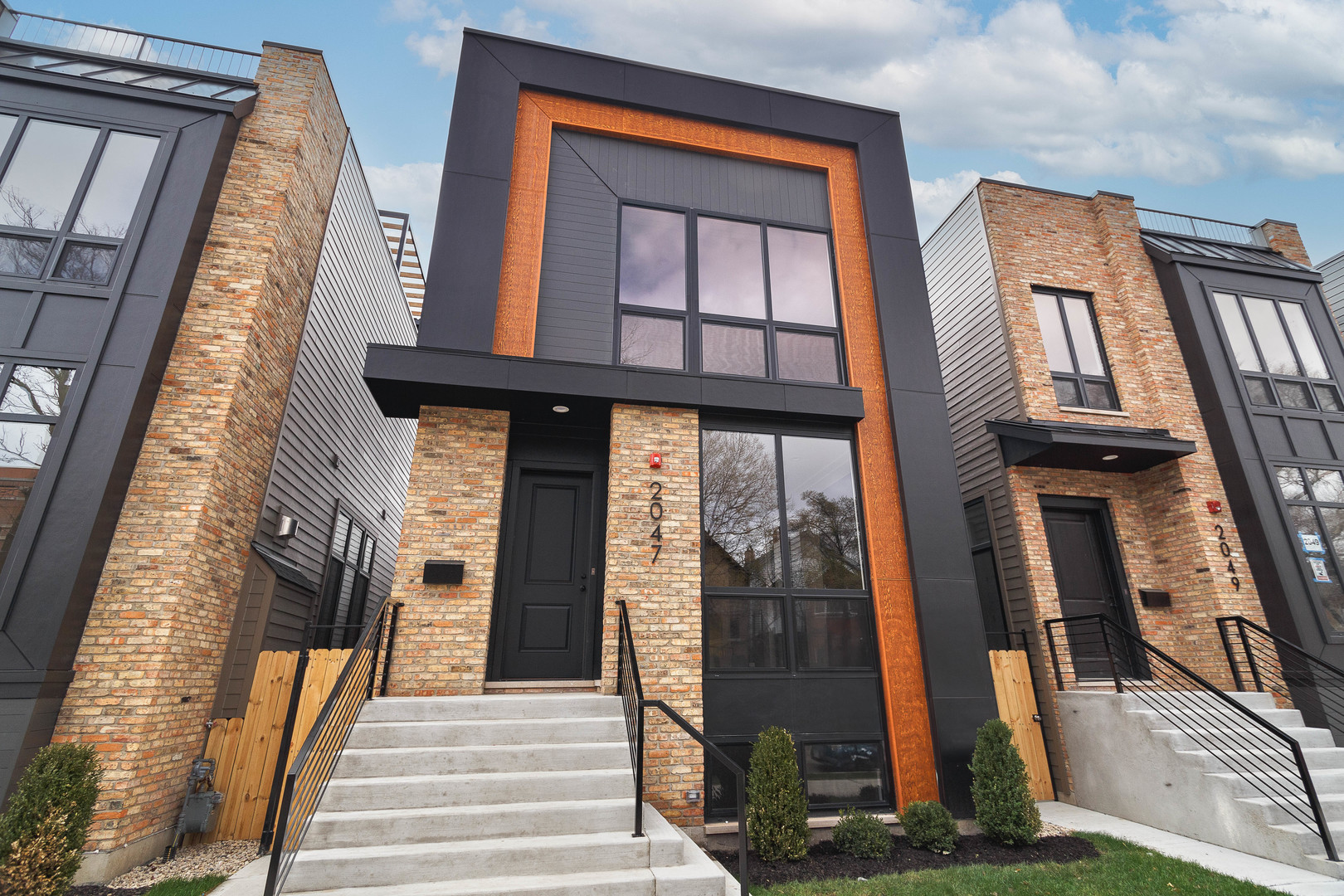 Don't miss your opportunity to check this exceptional new construction project out! Contemporary facade with clean lines and brick accents. Extra wide floor plan with high end fixtures and finishes. Modern, sun filled spaces with oversized windows. Open concept main-level perfect for entertaining. Combined living/dining area features direct vent gas fireplace with floor to ceiling surround. Chef quality kitchen includes top of the line Sub-Zero and Wolf appliances, custom cabinetry with quartz countertops, and  large island with bar seating. Expansive family room with second gas fireplace and a wall of back windows. Upper level primary suite with two WIC's and ensuite bath featuring a freestanding tub, frameless glass shower, dual sinks, and heated flooring. Two additional bedrooms, full bath with tub and dual sinks, and laundry with LG washer/dryer complete the level. Third floor wet bar opens to a roof deck with outdoor fireplace. Finished lower level features radiant heated flooring and includes a spacious recreation room complete with wet bar, fourth bedroom with large WIC, full bath with shower, utilities, and luxury vinyl plank flooring. Rear deck with staircase to garage roof deck with pergola. Prime West Town location close to restaurants, shopping, entertainment, and Smith Park! Easy access to public transportation and other great neighborhoods.