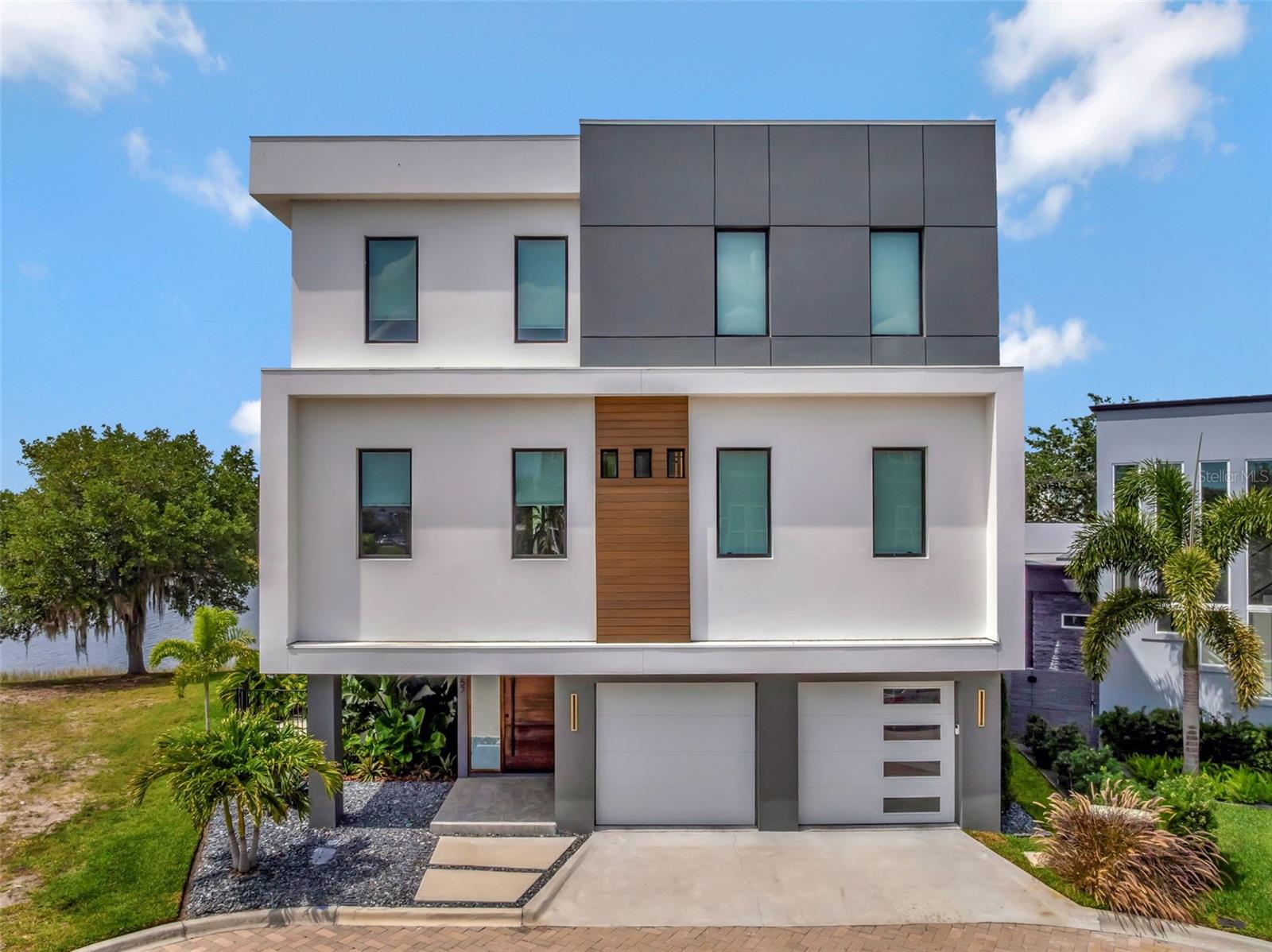 Under contract-accepting backup offers. Presenting the state of the art in luxury in Laureate Park, 8157 Elion St, Orlando, FL 32827. This custom built home sits on a premium waterfront lot and is walking distance to Canvas Restaurant, the Aquatic Center and fitness center! There is no sidewalk between property and pond, which offers ideal privacy. You can see and hear Disney fireworks from patio or hot tub on a clear night.The owners have put in over $300,000 post build on this home and the features are incredible! This is the only property in Laureate park to be constructed with all 3 levels masonry/poured concrete (instead of wood framing). 17 kW Tesla Solar System (largest in Laureate Park) and (2) two 17 kW Tesla Power Walls (automatic whole-home battery backup)! State-of-the-art SPAN breaker panels with Span Level 2.5 EV charger (WiFi control of entire home circuit breaker; connected to solar, EV vehicle charing, and energy optimization). From the minute you enter this home, your eyes are drawn to the serene pond view with views from every angle in the living room, dining and kitchen. Cathedral ceiling with stunning custom lighting and open concept. The first floor glass sliding doors are 15’ wide and 10’ high, with secondary windows above that illuminate the massive 25’ cathedral ceiling. Illuminated panoramic glass wine storage area offers a stunning vibe, especially in the evening. Gourmet kitchen provides full Thermador appliances with 2 dishwashers and built-in super automatic coffee machine. The modern "clean" kitchen aesthetic offers you a Hidden “butler pantry” for kitchen goods and appliances with separate sink. You can retreat upstairs either by the modern silent 4-person elevator with digital control pad or the Custom-fabricated on-site floating aluminum staircase with glass handrails. On the second floor you will enjoy the custom Full bar on second floor with water, sink, refrigerator/freezer combo with ice-maker, this is an ideal lounge, movie or game room. You have balcony access with gorgeous sunset views right off the lounge room. Laundry room offers a steamer and a laundry sink as well as ample storage space. There is a laundry chute from the 3rd floor for ease as well! All bedrooms offer en-suites and are spacious with spa style detail. Your Primary Suite is luxurious and spacious with private balcony access. The EXPANSIVE walk-thru primary closet is to die for! Offering motion sensor lighting, a built-in seated vanity desk with lighted mirror. Enjoy the built in fireplace for a most relaxing wind down as you relax in bed. Smart home shower in primary bathroom with 2 symmetric shower systems, each with rainfall, body jets, and hand shower. Spa style soaking tub inside the shower. The uncovered 3rd floor patio features a fire pit and permanently installed propane line. Designated pool bath on first floor provides easy access to inside. You also have a private outdoor shower with hot/cold features just outside the pool bath. Enjoy your custom salt water pool/spa and WIFI enabled features. The LED lighting can be customized and the pool/spa features automatic water leveling as well as automatic chlorine generating. Enjoy Florida Living year round in your stunning outdoor kitchen that provides Wolf 36” premium outdoor kitchen with two outdoor refrigerators, outdoor trash, outdoor beverage station bar sink. The grill chef will love the Long-term meat aging specialty refrigerator. Smart home lighting and blinds throughout.