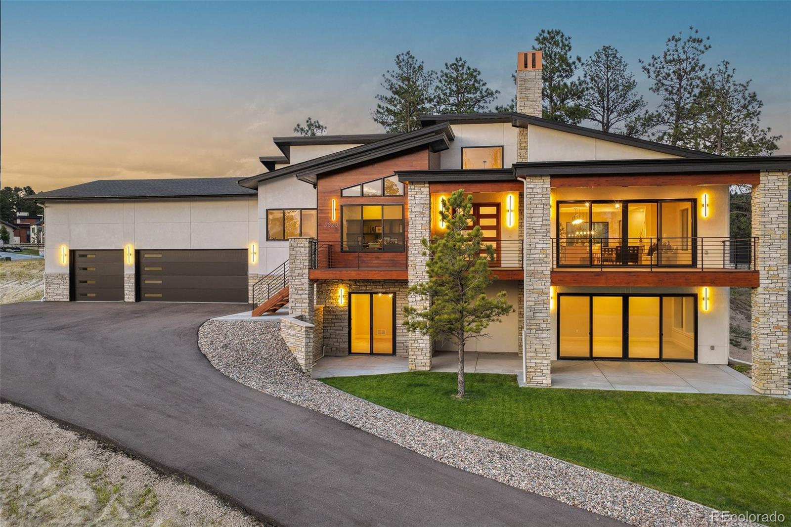 Designed to live beautifully from front to back, this mountain contemporary ranch pairs welcoming architecture with a highly functional floor plan that feels open, comfortable and well considered. Built in 2025 by Summerwood Homes in The Timbers at The Pinery, the residence offers over 5,400 total square feet, four bedrooms, six baths and spaces created for both everyday living and effortless entertaining.The main level is defined by volume, light and connection. Expansive windows frame the setting, while a dramatic floor-to-ceiling fireplace anchors the great room. The kitchen combines custom cabinetry, quartz surfaces and designer appliances with an oversized island, walk-in pantry and fully equipped back kitchen featuring additional refrigeration, a dishwasher and generous prep space. The dining area and outdoor living spaces extend the home beyond its walls, creating an easy flow for intimate evenings or larger gatherings.Privately positioned on the main level, the primary suite includes a beautifully finished five-piece ensuite, expansive glass shower, freestanding tub and substantial walk-in closet. A dedicated office, powder room, laundry and mudroom complete the level.The finished walkout lower level expands the home with three additional bedrooms, each with an ensuite bath, a spacious family and recreation area, custom wet bar with wine display and a versatile flex room suited for a theater, fitness studio, or game room. Outside, professional landscaping, a built-in fire pit and multiple places to relax or gather connect the architecture to the landscape.The oversized three-car garage is equally intentional, offering exceptional depth and 14-foot ceilings with room for full-size trucks, storage, hobbies, or vehicle lifts. Set on a .5-acre in a quiet cul-de-sac, 5820 Powell Road delivers refined materials, strong architectural character and a floor plan designed not simply to impress, but to live well. View More At: https://www.5820powellroad.com