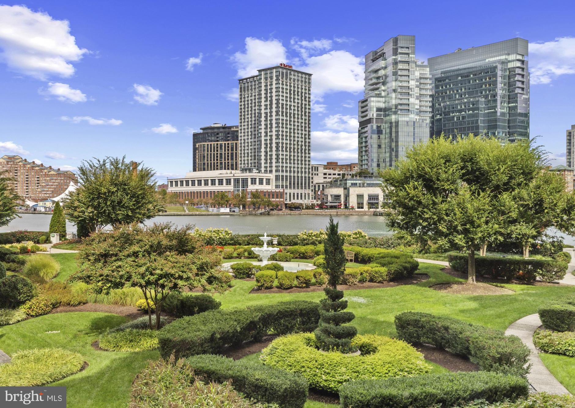 This gorgeous 2-bedroom and den, 2 full and one-half bath, second-floor residence at The Ritz-Carlton Residences, combines more than 2900 square feet of beautifully finished interior space with two large private balconies overlooking the harbor and main garden.  As one of the most spacious floor plans in the building, this residence features an inviting design that feels open while providing separation of space.  The incredible kitchen and dining area with beautiful views is a wonderful gathering spot with a stunning kitchen that features Viking appliances, a center island with bar seating, and one of the only full-sized kitchen pantries in the building. The living room centers on a gas fireplace and offers a wet bar as well as access to a private balcony with more gorgeous views.  An expansive den, perfect as a family room, home office, or library, flows seamlessly into the living room and kitchen, offering exceptional versatility for both everyday living and entertaining. The very private primary suite is a substantial size with room for a sitting area or office and walks-out to a covered balcony looking out to the water. The suite features an abundance of closet space and a luxury primary bathroom with a dual sink vanity, a soaking tub and glass-enclosed shower, and a private water closet that includes a bidet. The second bedroom is also generously sized and has its own en-suite bath. A powder room, full-size laundry, and thoughtful storage complete the interior.  Two deeded parking spaces and a separate storage area are included.  Residents enjoy exclusive access to on-site fine dining, a full-service marina, and a state-of-the-art medical and wellness spa, along with 24/7 concierge, valet, doorman, and porter services that define The Ritz-Carlton standard. Additional lifestyle amenities include an indoor pool, fitness center, theater, six private guest suites, and elegantly appointed event and entertaining spaces nestled within manicured gardens. Perfectly positioned on the Baltimore Promenade, with direct access to the waterfront, water taxis, and cultural landmarks, this home is just minutes from the city’s art scene, stadiums, Penn Station, and BWI Airport. Schedule your private showing today.