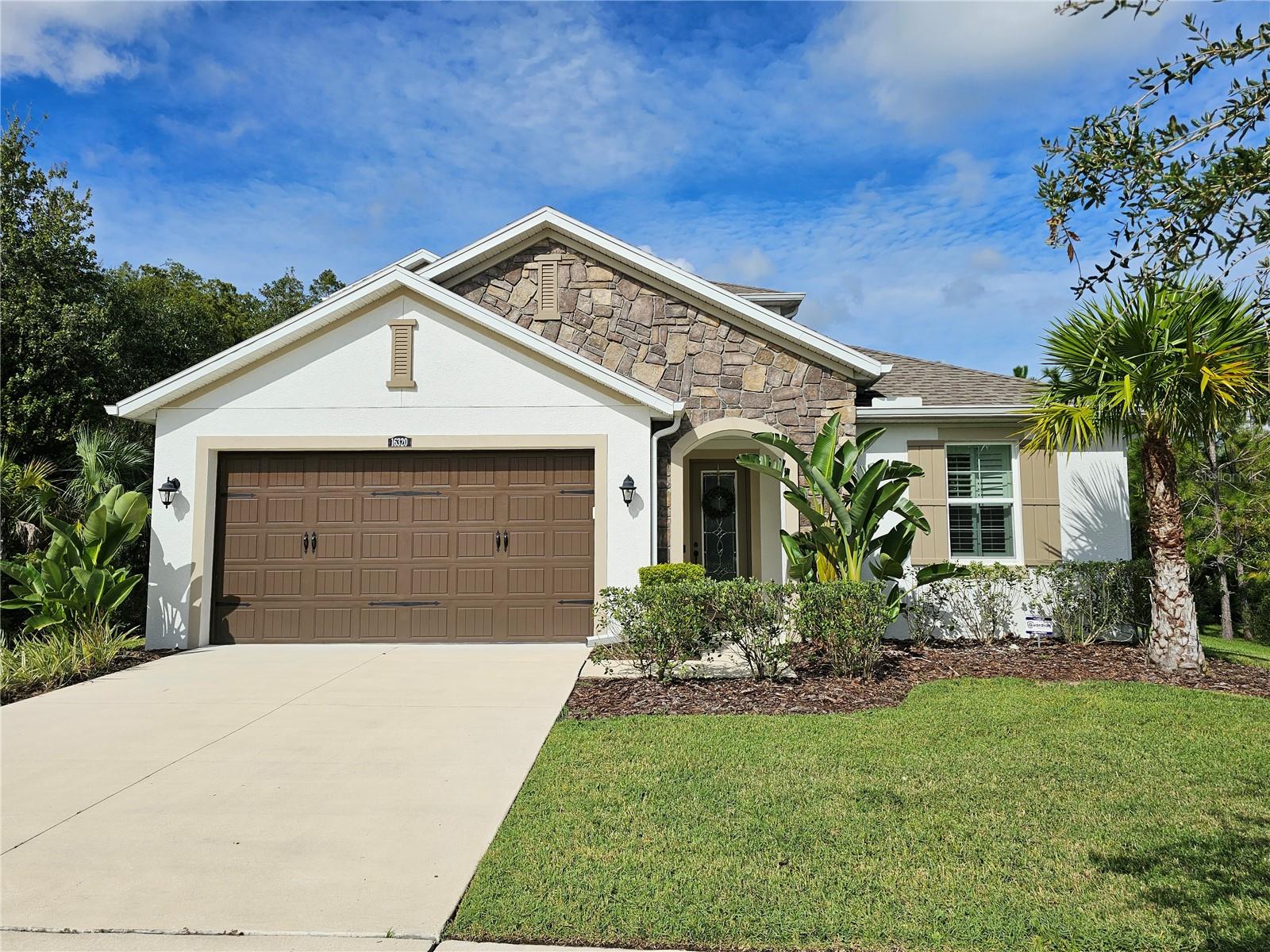 Under contract-accepting backup offers. Beautifully maintained, uniquely located, "stand-alone", home in Stafford Place at Tampa Palms.  Built in 2018, this four-bedroom, two bathroom home features a natural landscape buffer offering a serene backyard setting among cypress, pine, and grand oaks.  The custom water feature creates a calming and soothing ambiance that transports you from the hustle and bustle of New Tampa into a relaxing outdoor oasis.  The inside of the home features four bedrooms, including the master, on the ground floor with a spacious great room, upscale kitchen, and an enormous bonus room on the second floor.  The living areas are complemented with wood-grain ceramic tile, elegant plantation shutters, and high ceilings.  The bedrooms are warm and welcoming with cushioned carpets, plantation shutters, and ceiling fans.  The kitchen boasts a farmhouse style sink surrounded by marbled granite, stainless vent hood, glass tile backsplash, a double oven, and stainless appliances.  The large, screened lanai is surrounded by conservation and looks out on to the flowing water rock garden. The lanai also has plumbing connections in place awaiting the buildout of your custom outdoor kitchen.  This is home has it all!