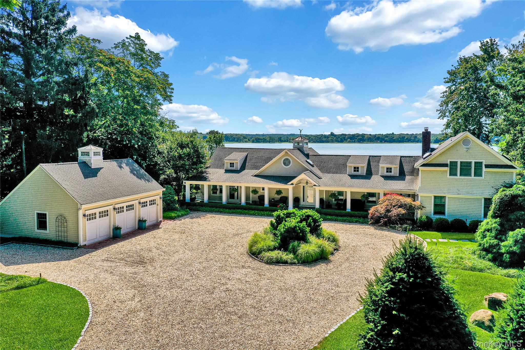 Introducing 111 Old Field Road, Setauket  a truly exceptional waterfront estate offering 177 feet of uninterrupted shoreline and panoramic views of Conscience Bay. Tucked away behind a long private drive, this majestic home sits gracefully back from the road, delivering the ultimate in privacy and elegance. The approach is breathtaking, and the beautifully landscaped grounds set the tone for what awaits. A three-car detached garage provides ample space for your vehicles, water toys, or collector’s items, while the backyard is a serene sanctuary featuring an in-ground pool overlooking the tranquil bay, a outdoor kitchen, and a pergola perfect for relaxing or entertaining. Inside, the home features an open-concept layout anchored by a designer chef’s kitchen with top-of-the-line appliances, flowing seamlessly into the sun-drenched living room, formal den, and an expansive sunroom — all framing picture-perfect views of the water. The main level hosts three spacious bedrooms, while the luxurious primary suite occupies a private wing upstairs, offering a spa-like retreat. Two additional upstairs bedrooms on the opposite side of the home create the perfect guest or in-law suite setup. With its ideal blend of modern sophistication and coastal charm, this rare offering in the heart of Old Field provides the ultimate lifestyle privacy, elegance, and the calming presence of the bay just beyond your backyard.