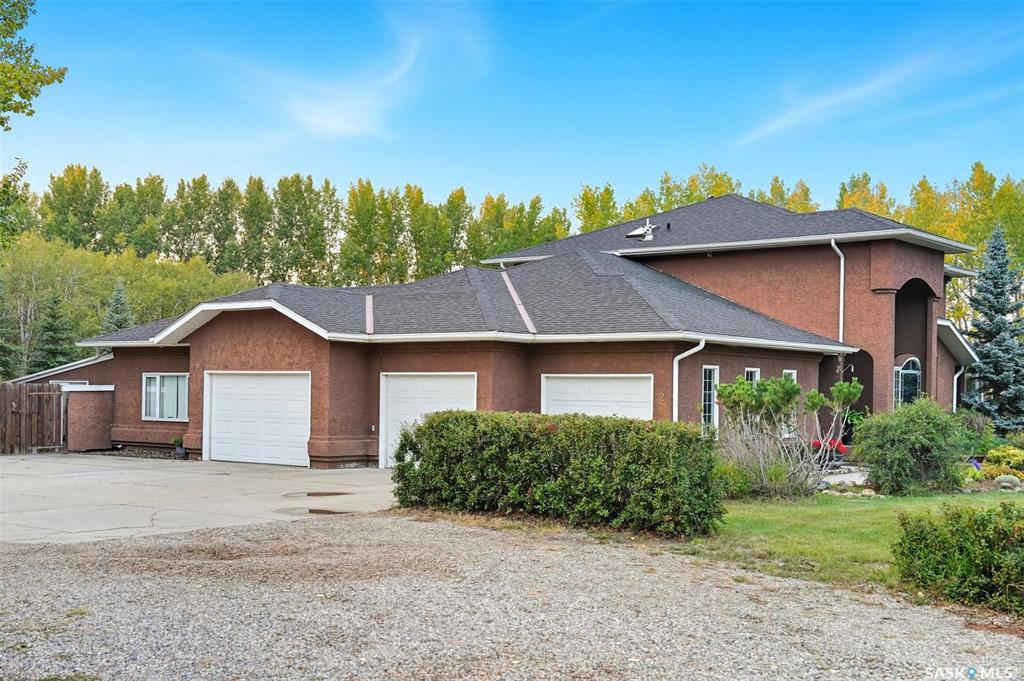 Highly desirable CEDAR VILLA ESTATES!!! Only ONE km from city limits! Enjoy the serenity of country living with city convenience such as treated SK water and high speed fiber internet!! Well maintained 2 story split offers the perfect blend of luxury and tranquility situated on well treed 2.81 acres. This home is designed for function, style and entertaining. Gourmet kitchen with maple cabinets, granite counter tops including the island, tiled back splash + a pantry. Open into the Livingroom which offers cathedral ceilings and gas fireplace. Garden doors to multi-level deck. Separate formal dining room is great for hosting functions. Main floor laundry. Primary bedroom is on the main floor as well with 4 pc ensuite and walk-in closet. 2nd floor has 3 more spacious bedrooms and another 4pc bathroom. Plenty more space in the WALKOUT basement! Complete with a family room with built-in feature wall including a gas fireplace. Garden doors from the sunroom to the amazing yard. There is also a games area and 2 more "flex" rooms for a gym or your favorite hobby with it's own 3pc bath. Upgrades included newer engineered hardwood flooring, furnace, water heater and A/C 4 years old. Attached oversized 3 car garage with attached heated work shop. PLUS a  detached 23'x13'7" garage. Plenty of room for the acreage toys! Perfect entertaining yard set up with in ground POOL and wrap around multi level deck complete with gazebo. The inviting pond adds to the aesthetic features and serenity of surrounding nature. Glorious heavily treed lot has plenty of space for out door activities. Inviting stone pathway leads to a private firepit area. There is a deep well for the yard watering along with underground sprinklers. Experience the perfect balance of luxury living and country charm in this Cedar Villa acreage!!
