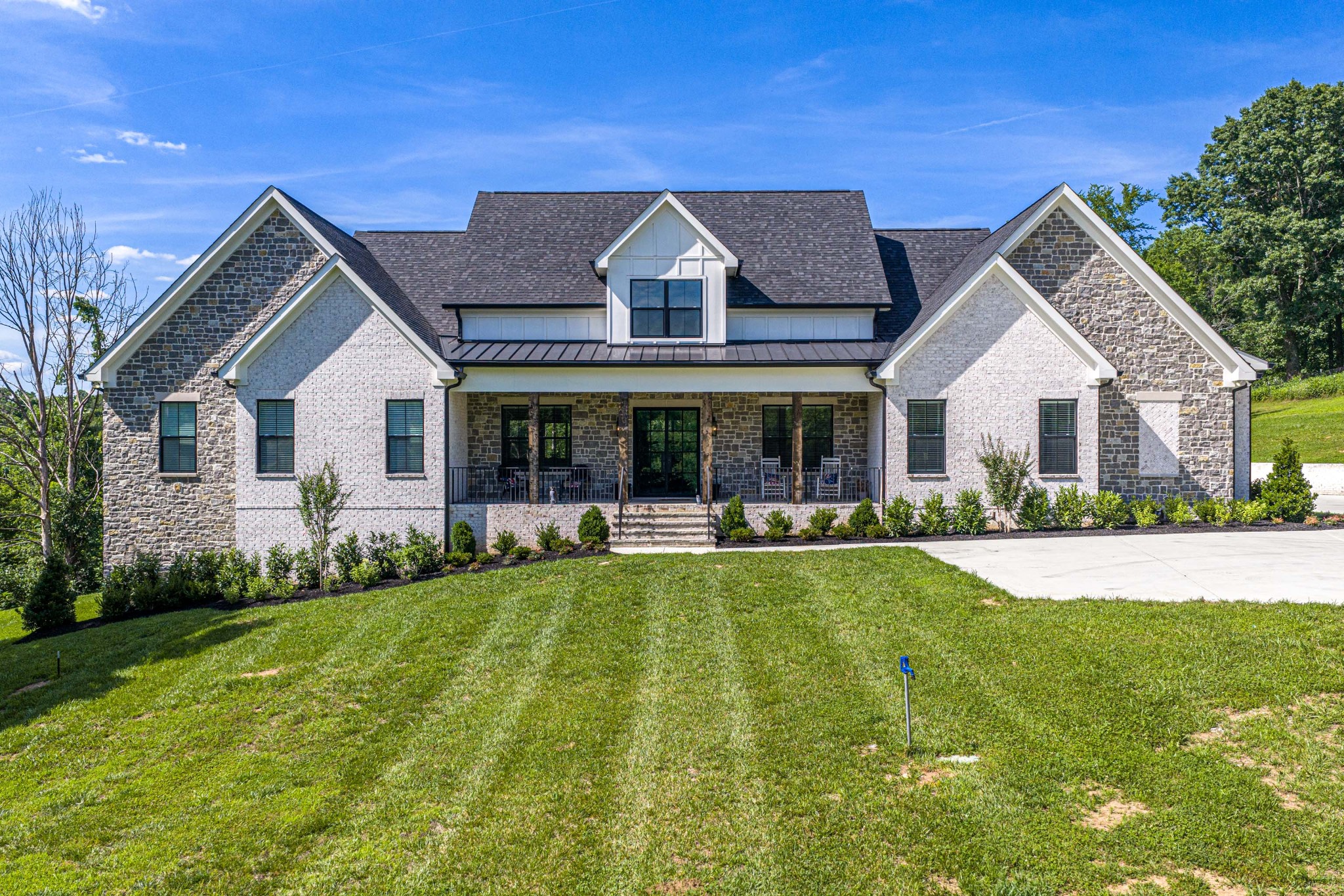 Step into this custom-built masterpiece, thoughtfully designed for both family living and entertaining. From the moment you enter, you are welcomed by soaring vaulted ceilings and a grand gathering room that creates an impressive first impression.The luxury kitchen is equipped with everything a chef could desire, including a Sub-Zero professional Frigidaire refrigerator and freezer, gas cooktop, double ovens, and a spacious hidden prep kitchen/scullery to keep everyday clutter out of sight. Expansive double sliding doors lead to a vaulted covered porch with a dedicated grilling area, creating the perfect indoor-outdoor entertaining space.The home’s layout is both functional and elegant. Tucked behind the kitchen, the laundry room flows seamlessly into the private owner’s retreat, offering convenience and privacy. The owner’s suite serves as a true oasis with generous space and thoughtful design.On the opposite side of the great room, you’ll find three spacious bedrooms, each featuring large walk-in closets and private or adjoining baths. The home office features vaulted ceilings, providing an inspiring workspace. An oversized three-car garage includes additional storage space for all your needs.The double bonus rooms offer endless possibilities and can be used as a game room, theater room, additional office space, fitness area, or children’s playroom.Downstairs, you’ll discover 1,139 square feet of open living space, with full bath making the space ideal as a mother-in-law suite, guest quarters, or the ultimate family hangout area.Tastefully designed and beautifully appointed, this exceptional home offers the space, functionality, and luxury to accommodate every stage of life.