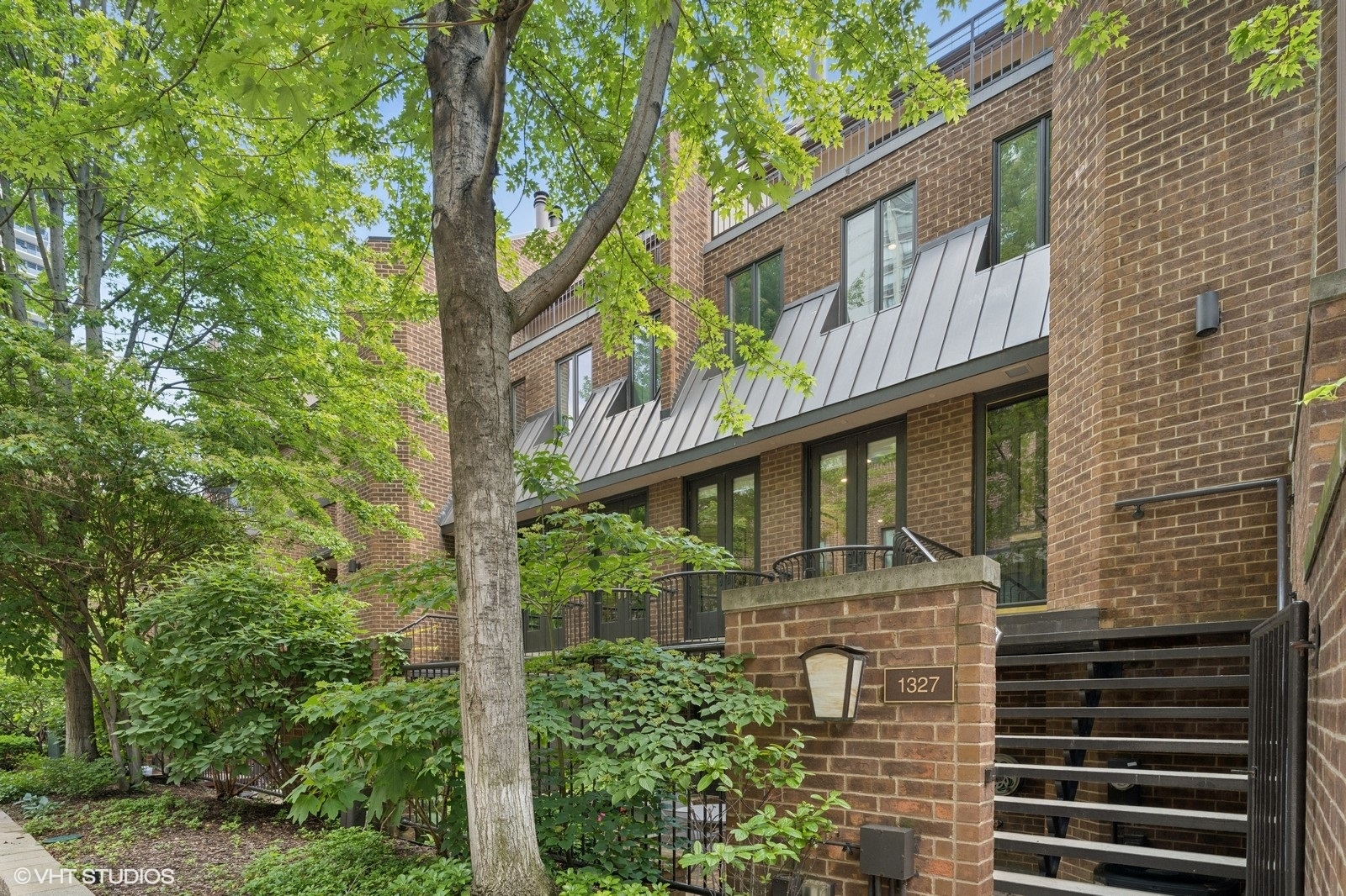 Exceptional 4-bedroom, 3.5-bath residence in the heart of Chicago' prestigious Gold Coast neighborhood. Nestled within Sutton Place, a rare and sought-after gated and door staffed enclave, this sophisticated townhome lives like a single-family home-without the upkeep. Step into a refined main level featuring hardwood floors, a generous living room with a wood-burning fireplace overlooking the beautiful tree-lined courtyard. The living room flows seamlessly into the dedicated dining area perfect for entertaining, and a timeless eat-in kitchen with stainless steel appliances and granite counters plus abundant storage and prep space. The second level includes three spacious bedrooms, a full guest bath with double vanity sink, and an oversized laundry room for ultimate convenience. Occupying the entire top floor, the luxurious primary suite is a true retreat. Enjoy soaring cathedral ceilings, a second wood-burning fireplace, two expansive walk-in closets, and a spa-inspired en-suite bath with your private full-width rooftop terrace. The lower level completes this space and offers a generous family room with high end custom built in storage, that opens onto your own private enclosed courtyard, blending indoor comfort with outdoor living. Attached 1 car heated garage plus additional storage in attic. Professionally managed 50-unit pet friendly association with private gated drive includes 24/7 on-site security, professional landscaping and snow removal. This urban sanctuary is located in top rated Ogden School district and just steps from the Lakefront Trail, Oak Street and North Avenue Beaches, world-class shopping on Michigan Avenue and Oak Street, charming Old Town, and the city's finest dining and cultural attractions. Effortless access to public transit, bike routes, and the Loop.