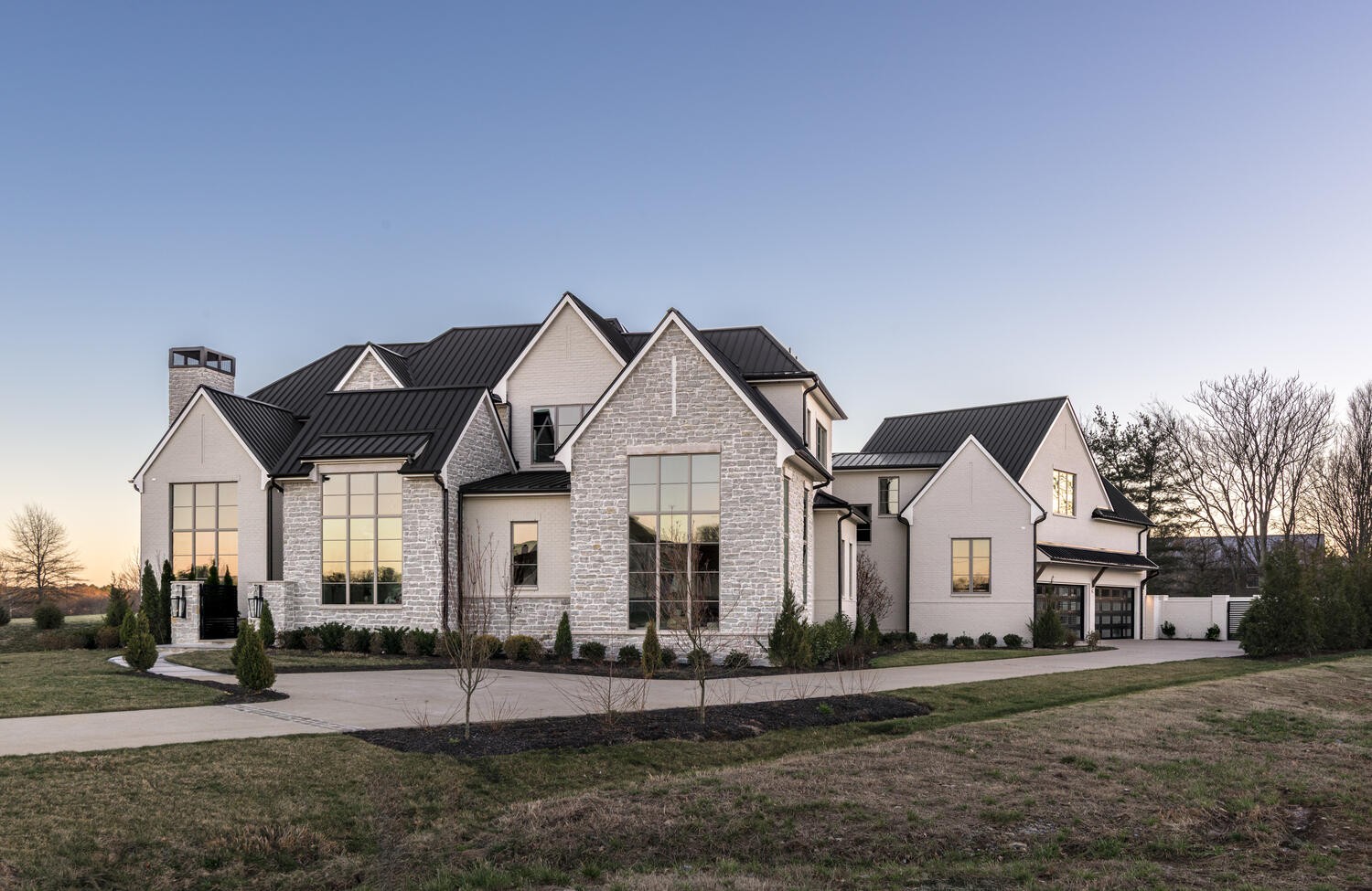 A distinguished estate offering within the gates of Anna, Brentwood’s most exclusive and private residential enclave. Thoughtfully designed for buyers who prioritize privacy, craftsmanship, and architectural character, this exceptional property offers a rare balance of convenient access and true seclusion, just minutes from Brentwood’s premier schools, dining, and retail. Constructed by Hidden Valley Homes w/ design selections by Studio 36, the residence reflects an uncompromising commitment to quality. The interior layout is refined and intentional, anchored by a chef’s kitchen featuring professional-grade appliances, porcelain countertops, custom white oak cabinetry, and a fully equipped butler’s pantry. Main living areas ascend via private stairs to an extraordinary entertainment level, featuring a dedicated media room, expansive rec room, and kitchenette.The primary suite is a serene private retreat on the main level, boasting spa-caliber finishes and dual oversized walk-in closets. Flooded with natural light through expansive walls of windows, the main floor also features a sophisticated study with gas fireplace and custom built-ins, plus two secondary bedrooms each with ensuite baths. Upstairs, discover two additional ensuite bedrooms, a versatile loft, and generous rec spaces for ultimate flexibility (elevator included). Outdoors, resort-style living awaits: a stunning luxury pool with integrated spa, dedicated sauna and pool bath, and a covered terrace complete with gas fireplace and full outdoor kitchen. Since purchase, significant owner improvements include a distinctive masonry privacy wall for unrivaled seclusion, full HVAC in the 4+ car garage (gym/showroom-ready), and bespoke floor-to-ceiling shades for light/privacy control.The homesite is surrounded by 6.24 acres of protected Anna Common Area, with an adjacent lot available for purchase, creating a remarkable 7.88-acre estate environment that cannot be replicated. By Appt Only.