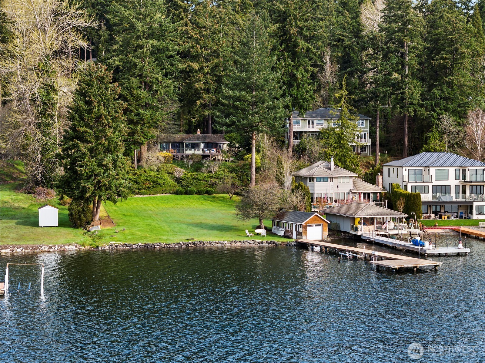 Spectacular waterfront acreage w/119’ of south-facing Juanita Bay waterfront! 5BR, 3BA 2,730SF w/ updated kitchen, hdwds & large newer composite deck. 64,203 SF (1.47 acres) w/lush plantings & huge lawn, boat house & 100’ dock. Southerly vistas looking at Mt. Rainier, Bellevue & Lk Washington w/ rose colored sunrises, golden sunsets & nearly endless maritime performances! Just blocks to Juanita Bay Pk & Juanita Village, 5-7 mins to dwntwn Kirkland’s eclectic shops & restaurants & I-405. Waterside oasis w/ expansive lawn is the perfect venue for festive celebrations – or peaceful enjoyment of life at its best. Whether you choose to renovate or build the large waterfront estate of your dreams, you don’t want to miss this amazing opportunity!