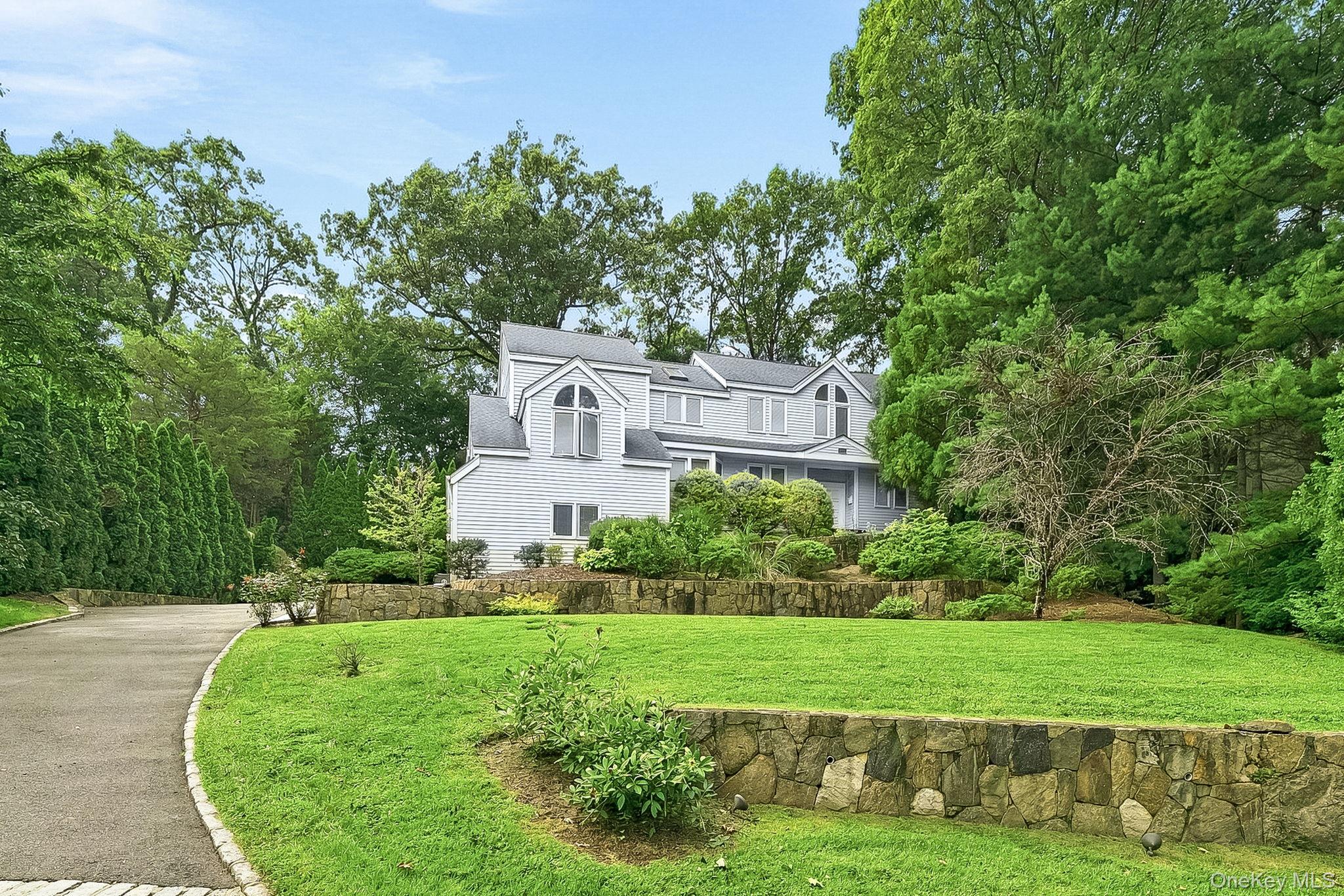 Set on a quiet cul-de-sac, this 5-bedroom, 3.5-bath Contemporary offers 3,550 square feet of bright, spacious living space. The .34-acre property backs directly to Scarsdale Golf Club, providing a scenic and open natural backdrop.The main level has an open concept design and infused with sunlight. It includes a gracious entry foyer, generously sized living and dining rooms, an eat-in kitchen with quality stainless appliances, a large center island with breakfast seating area. An adjacent family room features floor-to-ceiling windows and French doors that lead out to the deck and lovely rear yard. A first-floor bedroom/office offers flexibility for guests or work-from-home needs. Upstairs, the primary suite features vaulted ceilings, a walk-in closet, a luxurious ensuite bath and a private deck overlooking the Scarsdale Country Club Golf Course.  Three additional well-proportioned bedrooms and hall bath complete the second level. Special features include hardwood floors, abundant natural light, multi-zone central air, gas heat, central vacuum and an attached two-car garage, for comfort and convenience. Enjoy the privacy of this established golf-course cul-de-sac neighborhood, close to Hartsdale Village, Metro-North, shops, dining and Edgemont schools.