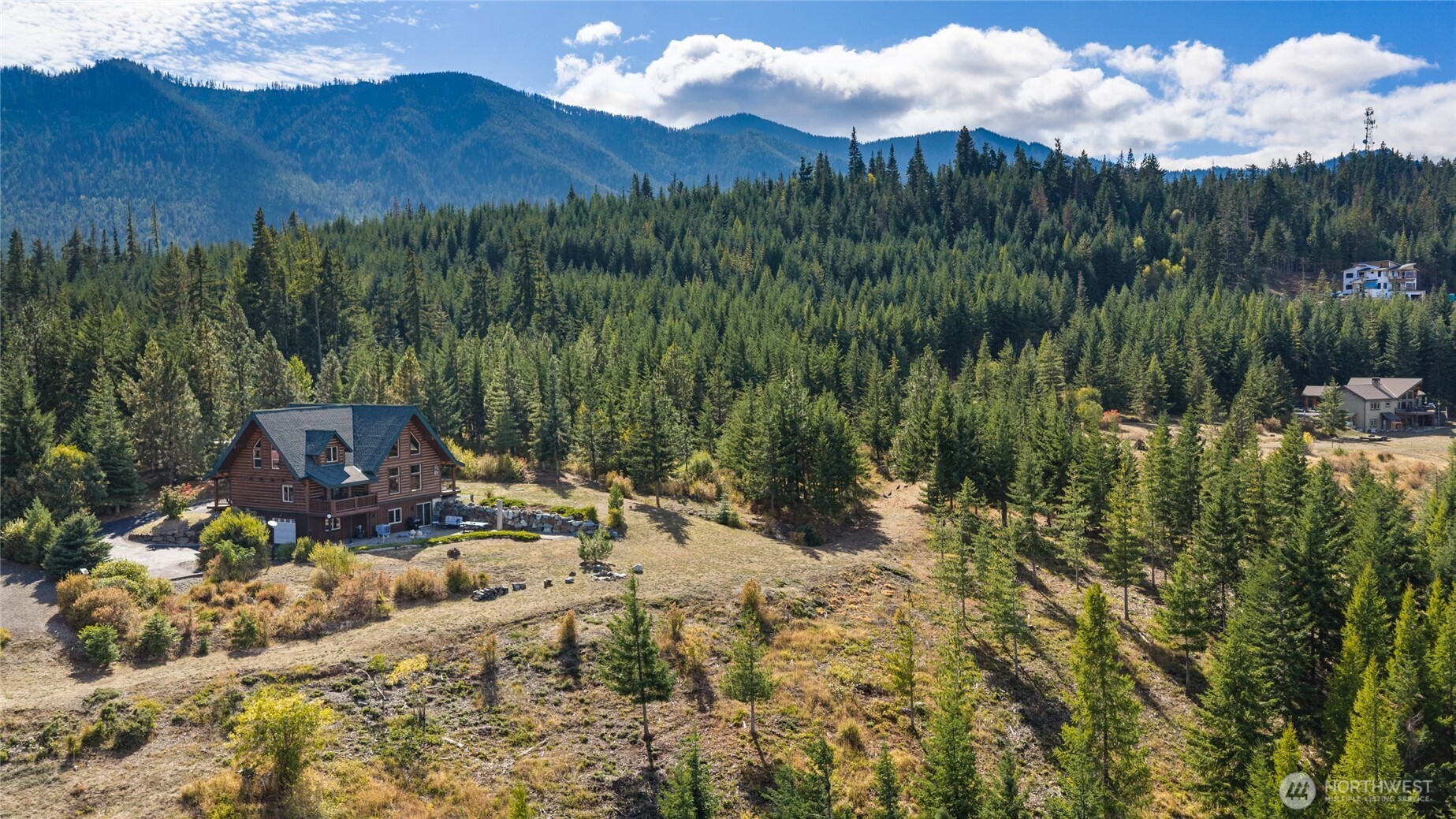 Expansive grounds surrounded by evergreens, offering a private mountain setting.