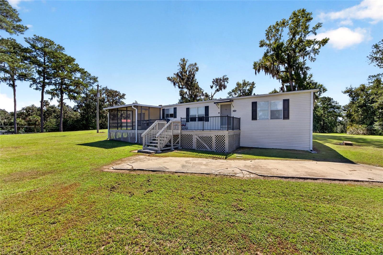 Looking for flexibility, space, and opportunity? This unique Belleview property features two completely renovated mobile homes on 2.64 acres, offering options to fit your needs! Live in the main home and rent out the second for potential rental income, create a multi-generational living arrangement, the possibilities are endless.The main home, a 1992 mobile home, offers 3 bedrooms and 2 bathrooms, laminate flooring throughout, and a cozy living room fireplace. The huge kitchen features a breakfast nook that opens to a screened porch, perfect for enjoying the Florida lifestyle. The spacious primary suite includes a large ensuite bathroom with a double-sink vanity, garden tub, and separate shower. Updates include the roof (2017), HVAC, and water heater.The second home, a 1968 mobile home, has also been completely renovated and features 2 bedrooms and 1 bathroom. Enjoy granite countertops in the kitchen, a large family room with a fireplace, and an updated bathroom. The roof was replaced in 2024, and the HVAC and water heater have also been updated.Four storage sheds provide additional space for tools, equipment, and storage. The property is zoned for multiple mobile homes, and the sellers have been advised by the county that two additional mobile homes may be permitted. Buyers should verify zoning, allowable density, and permitting requirements with the county. Both homes share a well but have separate septic systems.Conveniently located in Belleview, you're within reach of The Villages, Ocala, I-75, and the Florida Turnpike. Whether you're looking for rental potential, multi-generational living, or a property with room to grow, this unique opportunity offers plenty of possibilities!