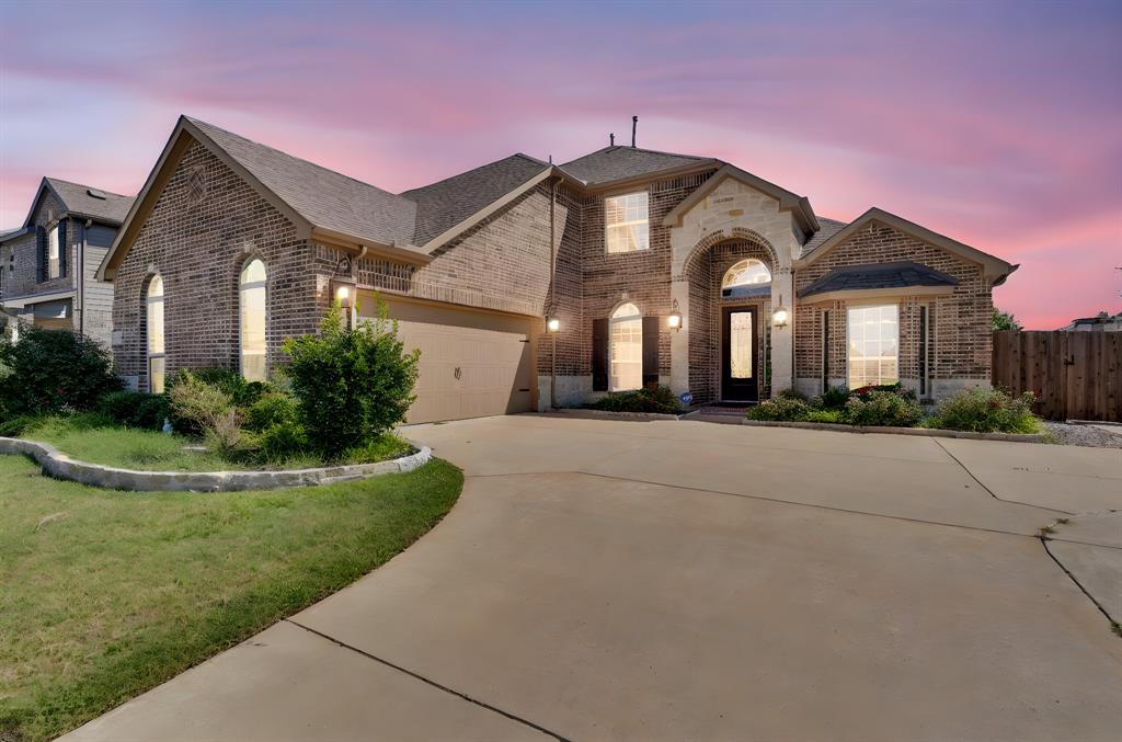 Situated on a spacious corner lot, this beautifully designed home offers an exceptional blend of elegance, comfort, and functionality. Manicured landscaping and strong curb appeal welcome you into a grand foyer with soaring two-story ceilings, abundant natural light, and refined architectural details including art niches and a sweeping staircase. The open-concept main living area features a dramatic floor-to-ceiling stone fireplace and oversized windows that frame views of the backyard, creating a seamless indoor-outdoor connection. The chef’s kitchen is thoughtfully designed for both daily living and entertaining, showcasing extensive cabinetry, granite countertops, stainless steel appliances, gas cooktop, double ovens, center island, and a dedicated coffee or prep nook. With five bedrooms and four full bathrooms, the home offers generous space for family, guests, or home office needs. An upstairs game room provides additional flexible living space ideal for media, recreation, or study. The backyard is a true highlight, designed for year-round enjoyment with a resort-style pool featuring stone accents and water features, along with an expansive outdoor living area complete with a built-in grill, bar, and multiple seating areas. The corner-lot layout provides added privacy, usability, and extra parking.Combining a functional floor plan, abundant natural light, elegant finishes, and a resort-inspired outdoor retreat, this home delivers an exceptional North Texas living experience