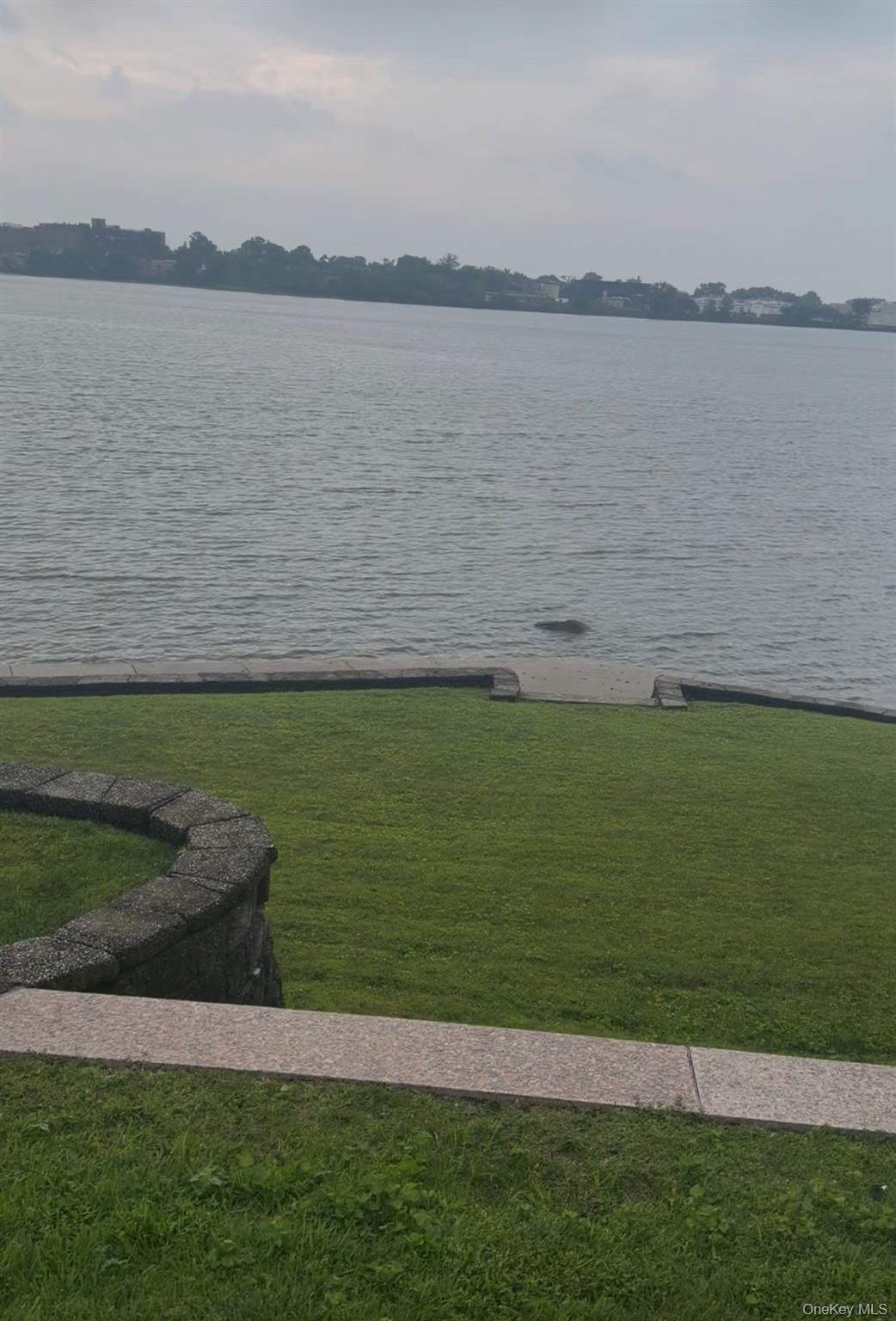 Welcome to this exceptional Waterfront Residence in the highly sought after Malba community of Queens. This distinctive brick and stone home offers 4 bedrooms, 3.5 bathrooms and four levels of beautifully designed living and entertaining space, all set against a serene East River backdrop. The elegant foyer and upper-level feature marble flooring, while the impressive living room boasts a dramatic cathedral ceiling and working brick fireplace. The lower level is designed for entering with a full wet bar, cocktail lounge, den, kitchen, bedroom, and bathroom, plus direct access to the waterfront patio featuring a full brick fireplace.Situated on as expansive 95'x190' lot, this unique property combines classic craftsmanship, generous living space, and incredible waterfront views. A rare opportunity to enjoy privacy, character, and waterfront living in one of queens most desirable residential neighborhoods.