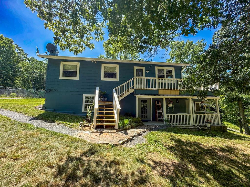 Welcome home to your own private mountain retreat! This charming 4-bedroom, 2-bath cottage with a guest house sits on 9.4 scenic acres bordering the Jefferson National Forest, offering the perfect blend of privacy and convenience, just 8 miles from I-77 and only minutes from the Appalachian Trail. Inside, you'll find a warm and inviting layout featuring a galley kitchen with pull-out shelving, a comfortable living room, dining room, two bedrooms, and a full bath on the upper level. The lower level offers two additional bedrooms, a bonus room currently used for storage, a full bath, laundry room, and a cozy family room with a wood-burning stove... perfect for relaxing after a day outdoors. The beautifully renovated 1-bedroom, 1-bath guest house provides an ideal space for family, friends, or potential rental income. Complete with its own tiki bar and freestanding fireplace, it's perfectly suited as an in-law suite, guest retreat, or short-term rental. Outside, you'll appreciate the detached garage and workshop with electricity, offering ample space for projects, storage, or hobbies. The property also features a chicken coop, goat pen, garden area, and a wraparound circular driveway that provides easy access and plenty of parking for guests. Whether you're enjoying the peaceful surroundings, exploring the Jefferson National Forest from your backyard, or hiking the nearby Appalachian Trail, this one-of-a-kind property offers the mountain lifestyle you've been searching for. If you've been dreaming of a place to slow down, reconnect with nature, and create lasting memories, this exceptional property is ready to welcome you home!