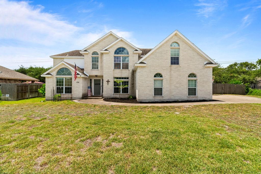 132 St Andrews | Rockport Country Club. A spacious and well-designed five-bedroom, two-story home. This inviting residence offers primary living on the main level, combining practicality with comfort for easy everyday living. As you enter, you're greeted by a private study on the left—perfect for a dedicated home office—and a formal dining room on the right that can also serve as a second study or flex space for those who work from home or love to entertain. The living area features a raised ceiling that enhances the sense of space and light, with clear views to the backyard, creating a warm and welcoming atmosphere for gatherings or quiet evenings at home. The open kitchen and dining area is designed for entertaining, offering plenty of room for meals or hosting friends. The primary suite on the main level is a true retreat with an oversized bedroom, private ensuite featuring double sinks, and a generous walk-in closet providing ample storage. Upstairs, all guest bedrooms are thoughtfully arranged, each with its own storage area, ensuring everyone has their own comfortable, private space. The layout balances shared living and individual privacy, making it ideal for families or those who enjoy hosting visitors. Set in the Rockport Country Club, the home offers an ideal location with a sense of privacy, established community charm, and easy access to local amenities, golf, dining, and coastal attractions. With space for everyone to feel at home and flexible rooms that adapt to your needs, 132 St. Andrews is the perfect blend of style, functionality, and location. Don't miss this opportunity to make this well-appointed, spacious home your own—schedule your private showing today and experience all the comfort and versatility this Rockport Country Club gem has to offer.