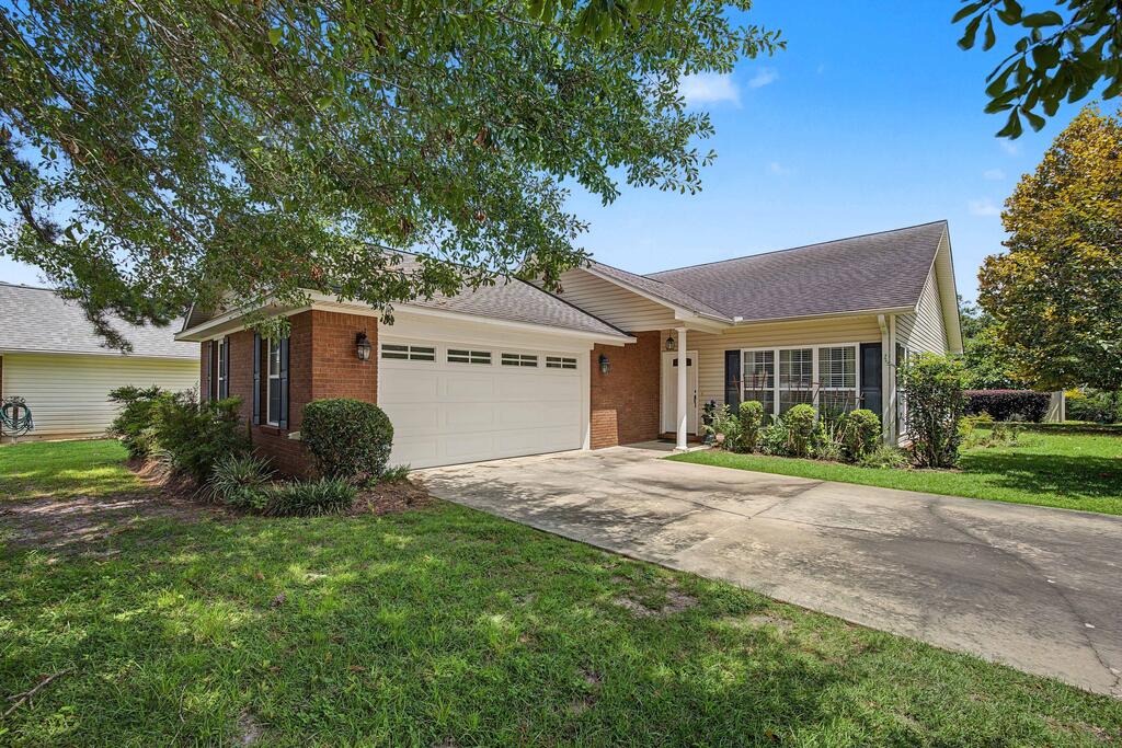 Located in Magnolia Pond subdivision, this home offers the ideal blend of convenience and privacy. Tucked within a small neighborhood, 127 Rachel Lane truly feels like a hidden gem.  With just under 1,800 square feet, the split floor plan features three bedrooms, two bathrooms, a formal living room, and a spacious kitchen that opens seamlessly into the den and dining room?perfect for both everyday living AND entertaining. Beautiful, low-maintenance wood and tile flooring extends throughout the home, adding warmth and durability.  A two-car garage and concrete driveway provide ample parking, while the covered back porch invites you to enjoy peaceful mornings and relaxing evenings outdoors.