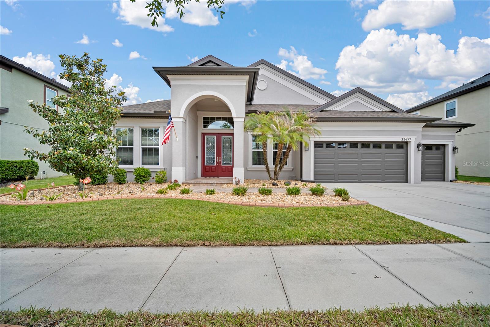Welcome to 32697 Natural Bridge, ideally situated “over the bridge” in the amenity-rich community of Union Park. Built by HOMES BY WESTBAY, this award-winning KEY LARGO floor plan showcases a thoughtfully designed split layout with soaring 12-foot ceilings that create an open, airy feel throughout the heart of the home. Additional living space includes a designated OFFICE with glass French doors, ideal for working from home, as well as a spacious BONUS room that offers endless flexibility for a media room, playroom, or guest retreat. Dramatic sliding glass doors frame breathtaking views of the SALTWATER POOL and SPA, all set against a serene backdrop of CONSERVATION AND POND VIEWS on an OVERSIZED homesite. The luxurious owner’s retreat is a true sanctuary, featuring a PRIVATE SITTING AREA and elegant French doors that open directly to your outdoor oasis. The chef’s kitchen is beautifully appointed with QUARTZ countertops and newer appliances making it both stylish and functional for everyday living and entertaining. Additional highlights include a NEW ROOF (2026), WATER TREATMENT SYSTEM with Reverse Osmosis in kitchen, Wall oven plus Convention/Microwave combo, under cabinet lighting, Kitchen island and laundry room custom cabinetry storage, an abundance of OVERHEAD storage in garage and gutters for added peace of mind. Inside, you’ll find NO CARPET throughout, CROWN MOLDING, and a stunning CUSTOM MILLWORK feature wall that adds warmth and character. Step outside to enjoy the screened lanai and fully fenced yard, offering the perfect space to relax, entertain, and take in the tranquil surroundings. Union Park offers its residents resort-style amenities including a lap pool, clubhouse, fitness center, splash pad, dog park, zen garden, playground, and miles of scenic biking and walking trails. Plus, CABLE/INTERNET is included in the HOA. Don’t miss your opportunity to own this exceptional home. Schedule your private tour today!