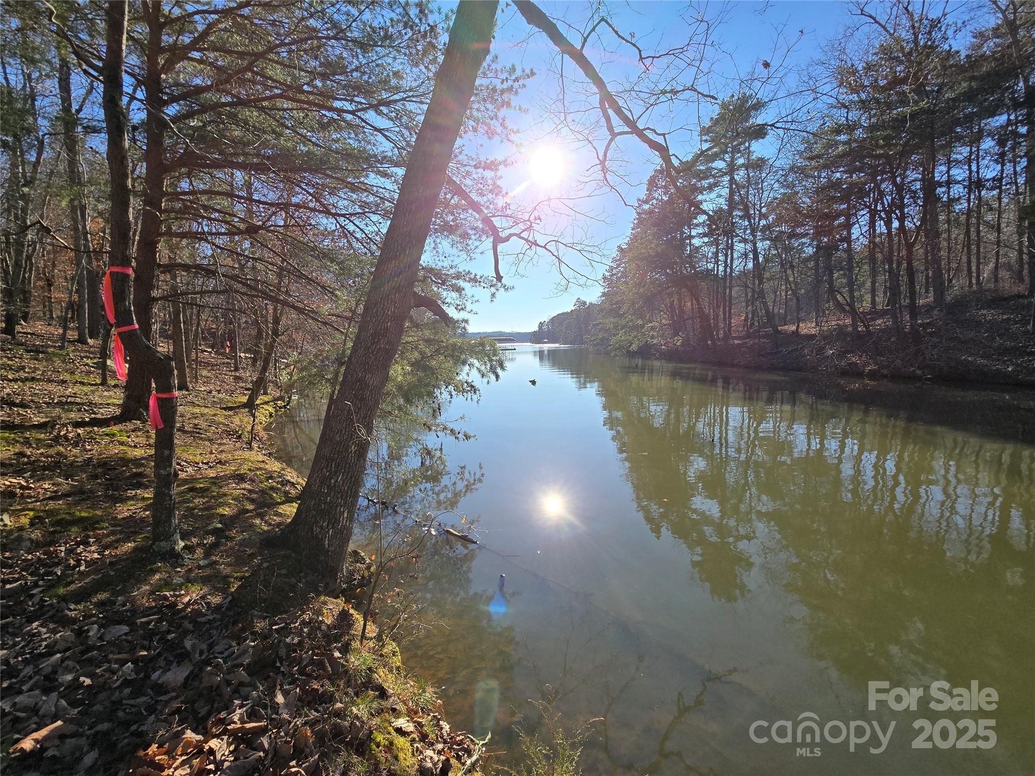 This Badin Lake waterfront lot is located in the prestigious gated community of Heron Bay. Great location along the Whisper Lake cove. New 4 bedroom septic permit 1-15-25, valid through 1-15-2030. .94 acre lot; lot lines recently marked by surveyor 11-21-24. Priced below tax value. The neighborhood includes a club house, paved boat ramp, community boat slips, walking trails, and boat storage. Heron Bay owners have the opportunity to join the adjacent Old North State Country Club. The Old North State Club offers a highly rated golf course, marina, club house, restaurant, pool, tennis courts, and more. Club opportunities require membership. Badin Lake has marinas that provide dining, gas & watercraft rental. The Uwharrie National Forest nearby is a great destination for camping, hiking, horseback riding, and ATV/OHV trails. Within one hour from Charlotte, Greensboro, and Winston-Salem.
