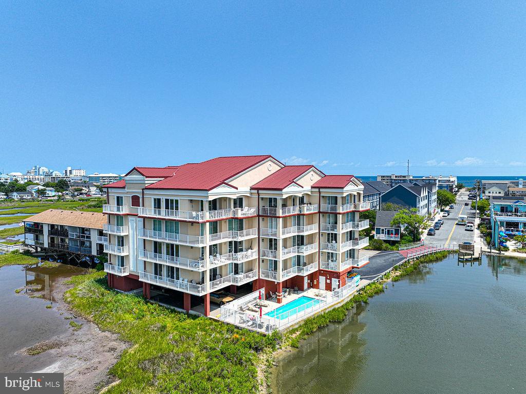 Luxury Bayfront Living with Spectacular Sunset ViewsExperience coastal living at its finest in this beautifully updated 3-bedroom, 2-bath bayfront residence offering 1,735 square feet in an exclusive 12-unit boutique building in the heart of Midtown Ocean City. Perfectly positioned with southern exposure, this exceptional home offers breathtaking panoramic views of the bay and protected wetlands.This meticulously maintained residence has been extensively updated with fresh paint throughout, upgraded recessed lighting in every room, new ceiling fans, all new electrical outlets and switches, new gas fireplace logs, Levolor® motorized shades, and heated distressed wide-plank tile flooring with 11 individually controlled heating zones. The Levolor® motorized shades feature room-darkening blinds in the primary suite and light-filtering blinds in the living room, while the gas fireplace creates the perfect place to relax on cooler evenings.The spacious kitchen is designed for entertaining and offers an abundance of cabinetry, quartz countertops, a coastal blue tile backsplash, stainless steel appliances, and a wine refrigerator a rare find for a beach home.The primary suite features a custom Elfa® Closet System by The Container Store and a stunning en-suite bath with upgraded fixtures and a spacious walk-in shower. A second Elfa® Closet System adds exceptional organization to one of the additional bedrooms. The second bathroom has also been beautifully updated with a spacious walk-in shower and seamless glass doors. The spacious laundry room has also been recently enhanced with the addition of a utility sink and custom cabinetry, providing exceptional storage and functionality.Step onto the expansive waterfront deck and enjoy spectacular sunsets, outdoor dining, or simply relax while overlooking the bay and protected wetlands.Amenities include a south-facing outdoor pool, barbecue area, covered parking, ground-level storage, secure lobby with elevator, and a kayak/paddleboard launch and storage area.Located in a well-maintained boutique building, this home offers a peaceful waterfront lifestyle just moments from Ocean City’s beaches, dining, shopping, and entertainment.Don’t wait on this one! Opportunities like this are rare. Schedule your private showing today and experience the very best of bayfront living in Ocean City!