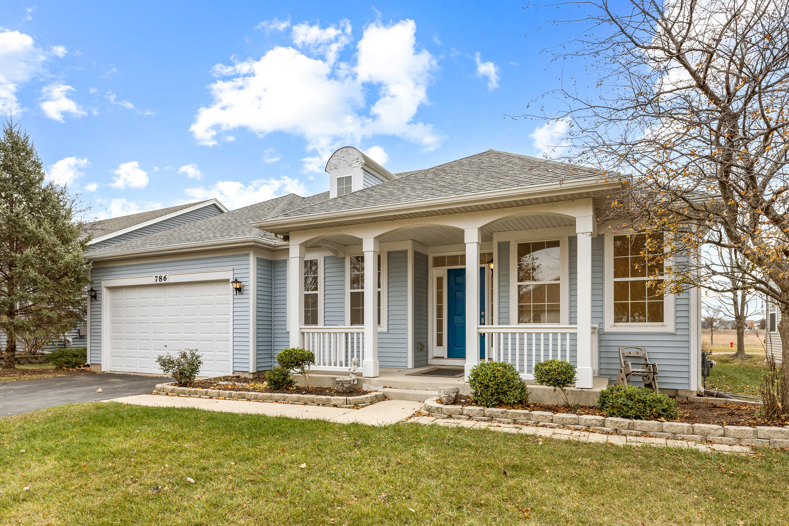 Be prepared to fall in love with this beautifully maintained 2-bedroom , 2-bath ranch located in the highly sought-after 55+ community of Steeplechase. From the moment you arrive, you'll appreciate the great curb appeal including a charming front porch, perfect for relaxing and enjoying the neighborhood. Inside you'll find a modern tiled foyer that leads into a bright, open floor plan filled with plenty of natural light. This home offers 9 ft. ceilings, 6-panel doors, and new designer hardware throughout. The spacious living and dining room combination features gleaming hardwood floors, creating an inviting space for everyday living and entertaining. The large family room is open to the well-appointed kitchen which includes quartz countertops and backsplash, a center island, 42" dark maple cabinets, a pantry closet, a stainless steel stove and dishwasher and a new stainless sink with a black faucet. A versatile den at the front of the home offers the perfect space for an office, hobby room, or cozy reading nook. The extra-large primary bedroom easily accommodates a sitting area and includes an expansive walk-in closet. Its beautifully tiled en-suite bath features a rare, and highly desirable no-step shower along with a new water-saving toilet. The second bedroom and additional full bath are ideal for guests. The guest bath has been completely updated to incude a new vanity,new designer faucets, a water saver toilet and beautiful step in shower with large subway tile surround, You'll also appreciate the large laundry room with wash tub and storage closet, plus a concrete crawl space-perfect for additional storage needs. Step outside to a large patio overlooking mature landscaping with an open view to the conversation area, offering a peaceful setting for outdoor dining or simply unwinding. Enjoy low-maintenance living with low HOA fees and no Master HOA fees. Gather with your friends in the well appointed clubhouse or at the pool in the summer which are all a part of the community. Scenic walking paths wind throughout the community, adding to its welcoming atmosphere. The home has been freshly painted throughout,has all new lighting,new cabinet hardware, and a new patio door. Also include the hot water, roof, furnace and AC that have been replaced within the last 5 years. All of this is just minutes from shopping, restaurants, parks, and a golf course, -everything you're looking for in a 55+ community!