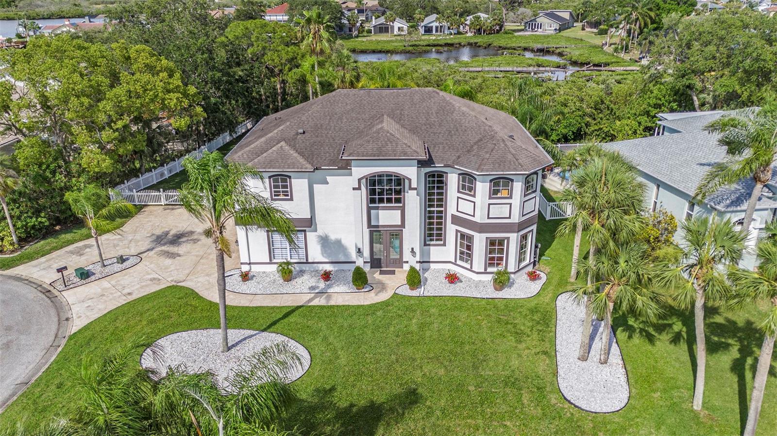 Experience the ultimate Coastal Florida lifestyle in this exceptional 4,000+ sq ft pool home, perfectly positioned on a large, private lot in Gulf Harbors with views of the Robert Crown Preserve and St. Andrews Creek. Surrounded by nature and water, this home offers space, privacy, and resort-style living.The lower level is ideal for flexible living and entertaining, featuring a massive great room/flex space with a fireplace, a fourth bedroom, and a full bathroom—perfect for guests, multigenerational living, or a home theater or game room.Upstairs, the home opens to a light-filled open floor plan designed for coastal living. The living and dining areas flow seamlessly into a high-end kitchen complete with a large island and stainless steel appliances—perfect for hosting after a day on the water. The split-bedroom layout provides privacy, with two bedrooms and a full bath on one side, while the luxurious primary suite feels like a private retreat, offering a stunning spa-style bathroom, dual walk-in closets, and private access to one of the expansive screened patios.Step outside and enjoy true Florida outdoor living. The beautifully landscaped lot offers peaceful preserve views, a huge heated saltwater pool, and two oversized screened-in patios, ideal for morning coffee, sunset cocktails, or entertaining year-round.Located in the sought-after Gulf Harbors community, residents enjoy access to tennis courts, a community pool, a boat launch, and optional beach club and yacht club memberships—bringing boating, beach days, and an active waterfront lifestyle right to your doorstep.This is a rare opportunity to own a spacious, private, amenity-rich home in one of New Port Richey’s premier coastal communities—where everyday life feels like a vacation.
