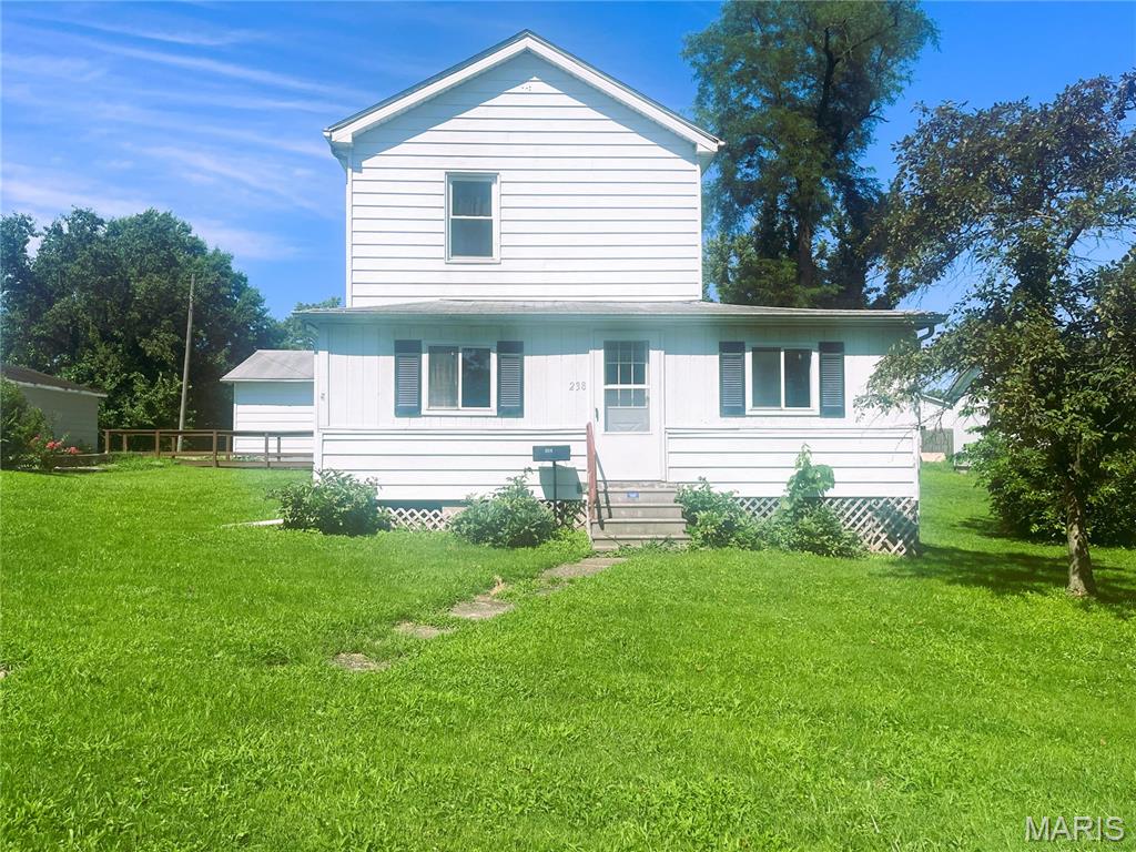 Welcome to 238 N Main St, located in the heart of historic Hillsboro, Illinois. This charming home offers 1,520 square feet of comfortable living space on a spacious 9,450 square foot lot. With two bedrooms and two full bathrooms, the layout is both functional and inviting.
Enjoy quiet mornings on the enclosed wraparound front porch, or entertain guests on the backyard patio, complete with a cozy chiminea perfect for cool evenings. A two car detached garage provides ample storage and parking.
Nestled within walking distance of downtown Hillsboro, this property combines small town charm with convenience. Don’t miss the opportunity to own a piece of local history with all the modern comforts.