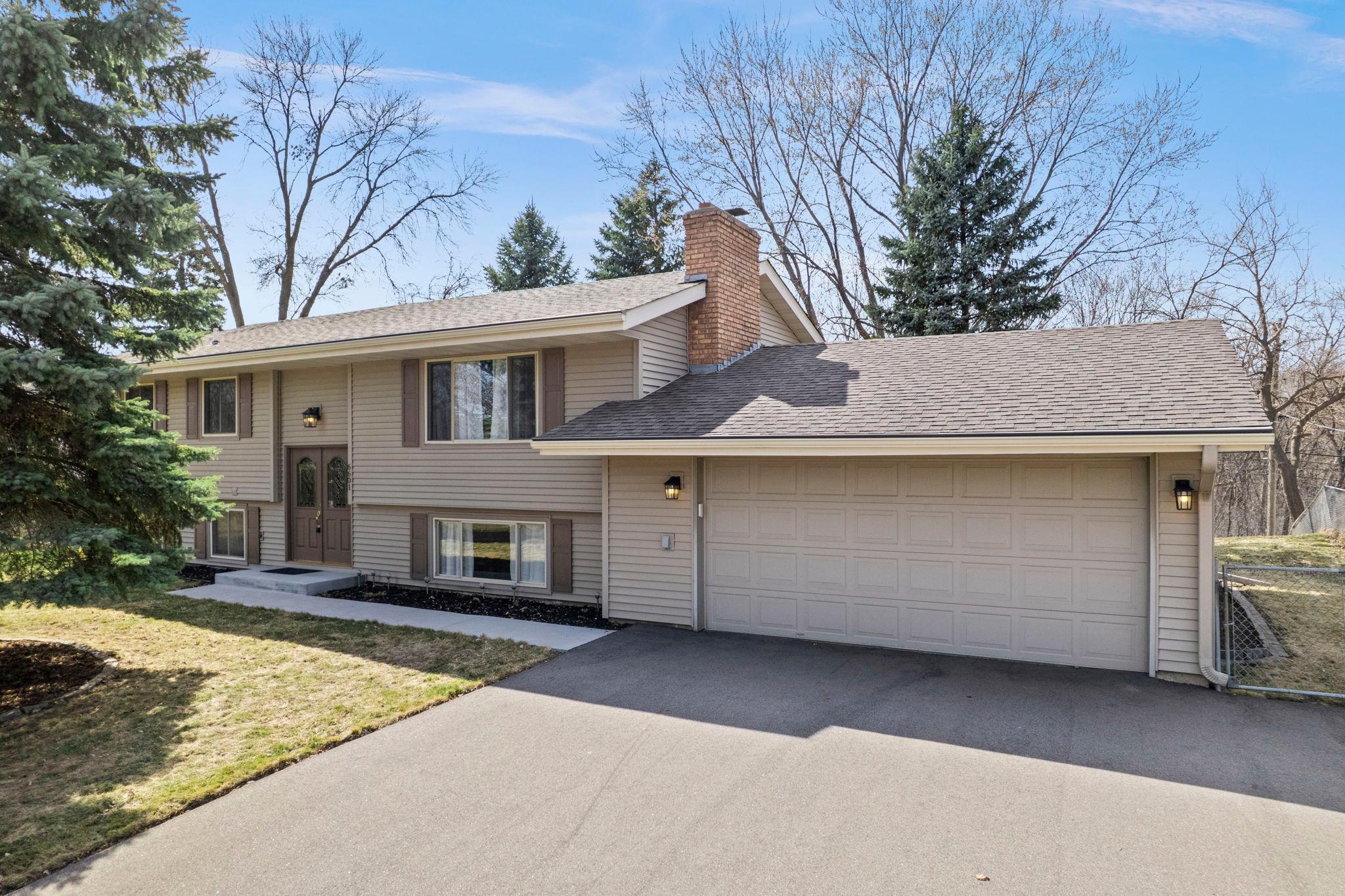 Welcome to this spacious and beautifully updated 5-bedroom, 2-bathroom home, perfectly tucked into a quiet, established neighborhood just steps from Bass Creek Park. Enjoy easy access to scenic trails, outdoor recreation, Arbor Lakes shopping and dining, and major highways, offering the ideal blend of everyday convenience and a peaceful retreat.French doors open to a bright, expansive living space where vaulted ceilings and a large picture window create an airy, inviting atmosphere. Updated hardwood floors flow seamlessly into the dining area, perfect for gathering and entertaining, with direct access to the spacious deck for effortless indoor-outdoor living.The kitchen shines with granite countertops, abundant cabinetry, under-cabinet lighting, stainless steel appliances including a double oven, and a center island with breakfast bar seating. Three main-level bedrooms provide comfortable space, including a primary suite with dual closets, along with a full bathroom nearby.The lower level expands your living space with a large family room featuring a classic brick wood-burning fireplace, two additional bedrooms, and a newly updated bathroom (2026). A convenient laundry and mudroom connects to the attached two-car garage.Outside, enjoy a fully fenced backyard surrounded by mature trees, plus a large deck. A parking pad adds extra parking space. Thoughtful updates throughout offer lasting comfort and peace of mind!