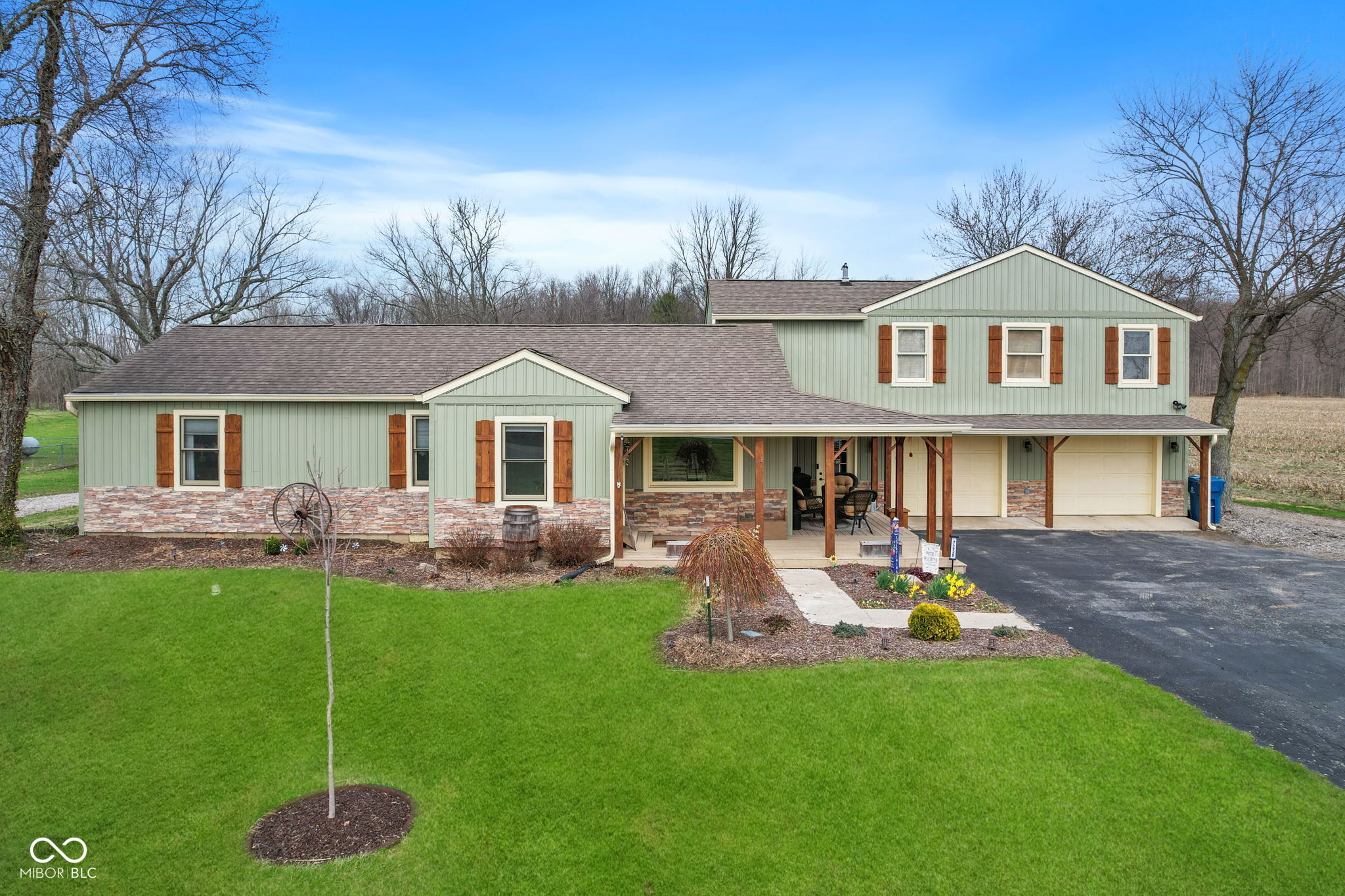 This inviting property on just under 2 acres, offers a peaceful country setting while keeping you conveniently close to city amenities. Inside, you'll find five bedrooms and three bathrooms, one of the bedrooms is currently being used as a home office.  Two bedrooms and a bonus room offer a separate entrance that are perfect for in-laws, guests, or an optional private suite that adds a versatile living space. The heart of the home features a kitchen refreshed with new LVP flooring, an upgraded sink, and warm butcher block countertops that complement the overall feel. Outdoors, a 30x45 pole barn with 200-amp electrical service and a workshop area with concrete floors provides ample space for projects and storage. The property also includes a partial wrap-around front porch with cedar-wrapped posts, a back deck with railing and a relaxing hot tub, and a fully fenced area ideal for pets. A chicken coop with 10 laying hens adds charm and sustainability. Recent exterior upgrades have refreshed the home with new siding, stone accents, fresh paint, and cedar shutters, while city water ensures reliable service. Storage galore throughout the property, with the additional outbuildings, ample interior closets and attic space. Located in the Clark Pleasant school district and close highway access. This home is truly move-in ready.