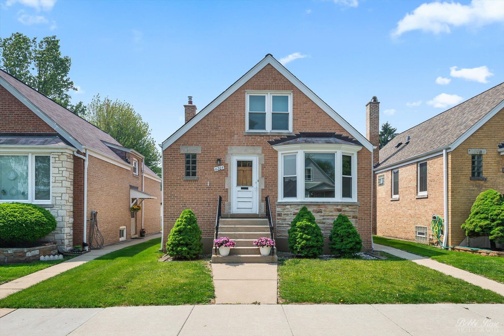 Set on a tranquil, tree-lined street in Chicago's Portage Park enclave, this striking 4-bedroom, 1.5-bath brick residence blends 1940s character with contemporary convenience across its 1,461 sq ft interior! Steps lead up to the elevated front porch, welcoming you into a sunlit living room anchored by a scenic bay window that illuminates glowing hardwood floors and graceful archways that hint at the craftsmanship throughout.  Your daily rhythm finds balance within the generous kitchen with its tiled backsplash, ample cabinetry, and suite of modern appliances, while morning coffee in the window-side dining alcove overlooking your fenced backyard offers a peaceful start to the day. Two serene bedrooms on the main level provide versatility, while two carpeted retreats upstairs share a thoughtfully placed half bath.  Weekends were made for relaxing and hosting lively BBQs on your lawn with its concrete patio and alley access. And when it's time to tackle laundry or rotate your seasonal decor, the expansive daylight basement, with a utility sink and abundant storage, delivers practical solutions. A detached 2-car garage and a brand-new heating and air system ensure comfort year-round.  Close to the historic 36-acre Portage Park, enjoy its sports fields, nature gardens, public pool, and vibrant community centers. With proximity to Wilbur Wright College, transit hubs like Jefferson Park, the Montrose Metra, and major shopping centers, you'll also have I-90/94, Wrigley Field, Lake Michigan beaches, and downtown Chicago all within easy reach.  When location, style, and quality come together like this, seize the opportunity to discover a home that can redefine the next phase of your life!
