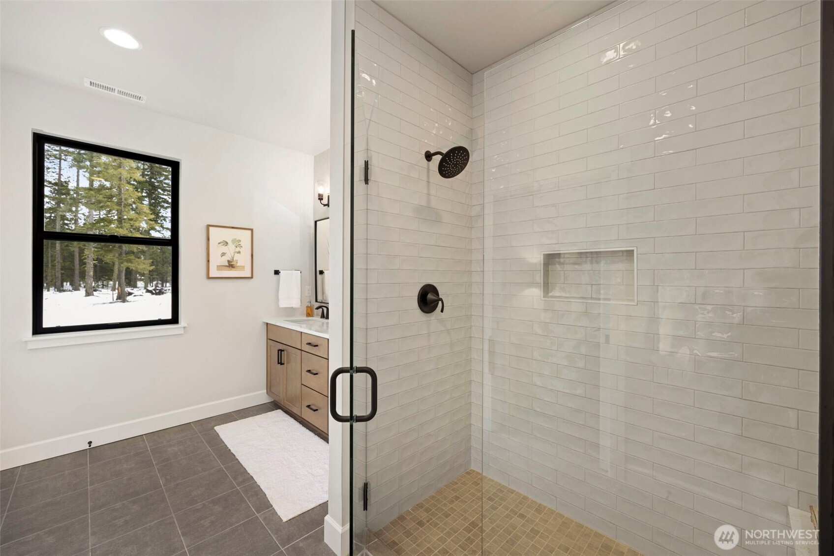 A spacious primary bathroom creates a relaxing retreat, complete with a generous walk-in closet offering plenty of room for storage and organization.