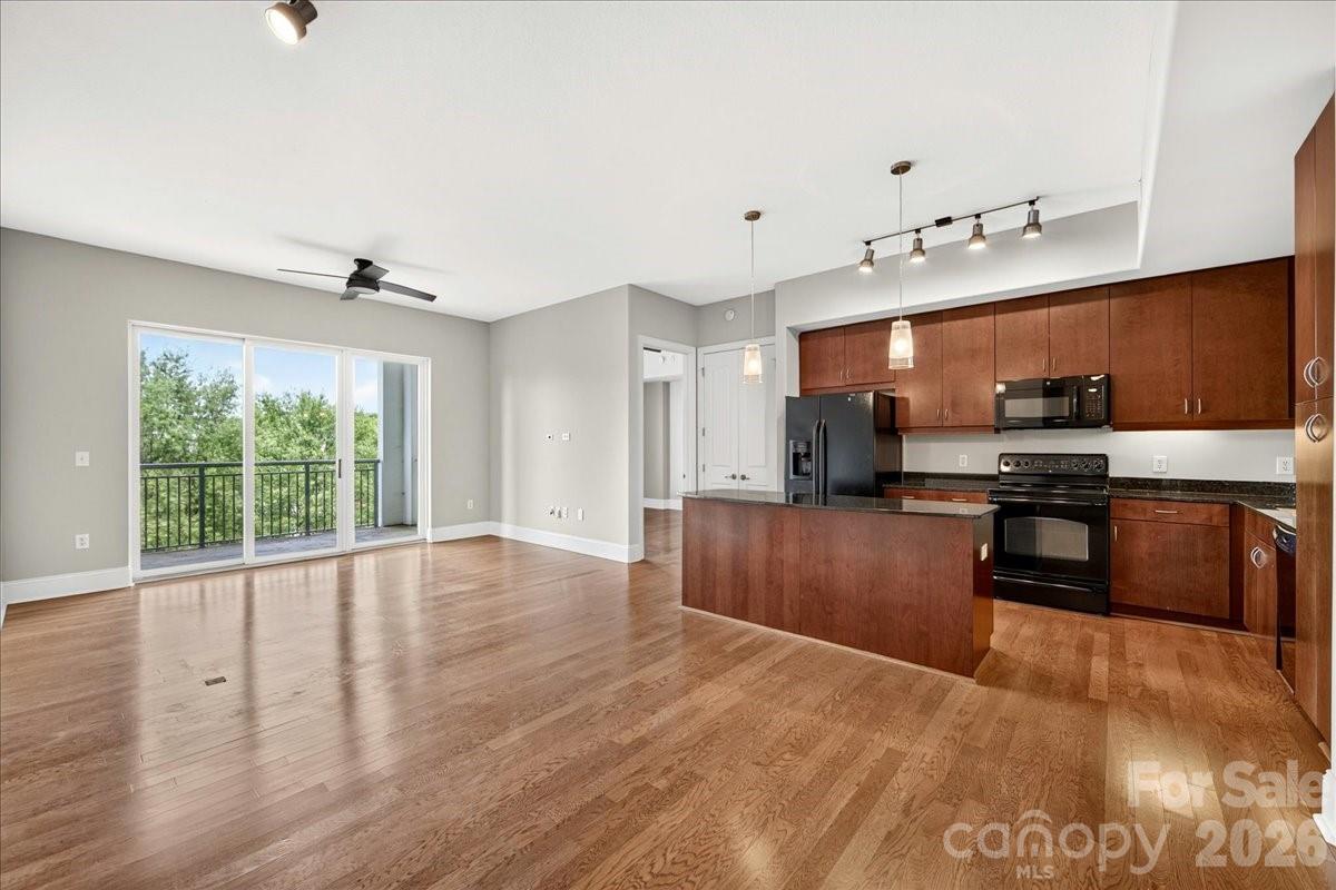 Stunning 5th-floor urban condo in the heart of South Park at Piedmont Row! This modern luxury home offers unbeatable convenience and a bright, open-concept living space. Expansive windows and sliding door lead to a covered, private terrace featuring beautiful treetop views overlooking Carnegie Blvd. Boundless upgrades include rich hardwood flooring throughout the entire unit (including both bedrooms), custom closet systems, and updated ceiling fans. Major mechanical peace of mind with a brand-new HVAC and water heater (both replaced in 2026). Rare convenience with 2 dedicated, gated parking spaces located on the exact same level as the condo. Live the ultimate lifestyle just an elevator ride away from premium restaurants, coffee shops, luxury shopping, a fitness club, a local brewery, and Symphony Park. A rare, move-in-ready gem in a spectacular Piedmont Town Center location!