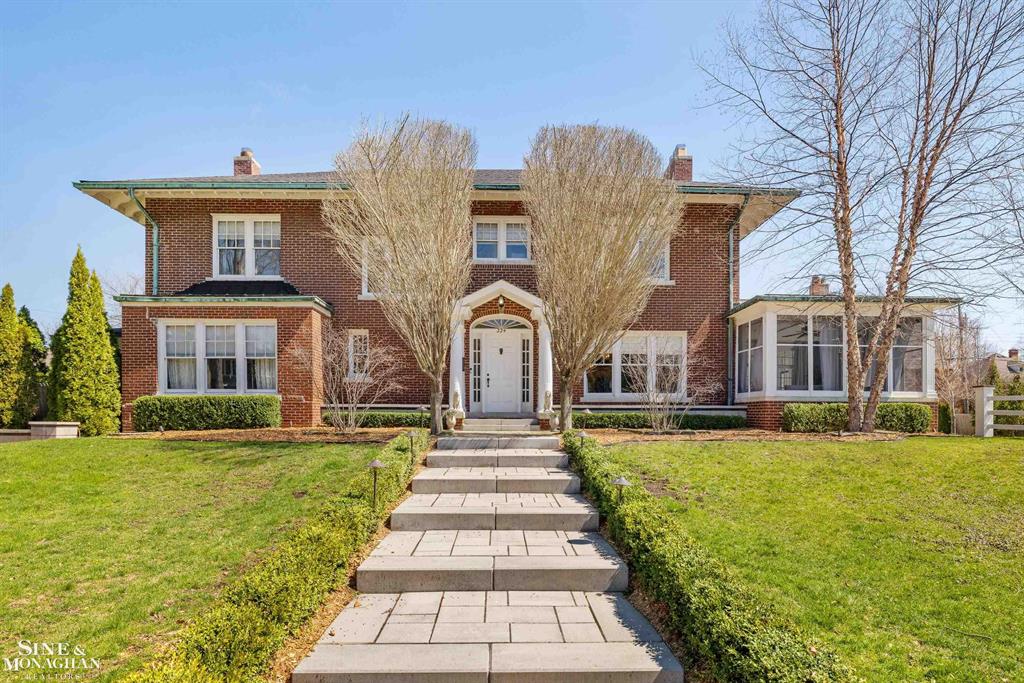 Welcome to 334 University Place in Grosse Pointe. A distinguished offering that showcases architectural and masterful craftsmanship embodying true charm and elegance. This is pure perfection at its finest with exquisite attention to detail evident throughout every inch of the home. Set within a prestigious neighborhood, this residence presents a rare opportunity for the most discerning buyer seeking timeless sophistication and modern luxury. Upon entry you are welcomed by beautifully proportioned interiors featuring rich hardwood flooring, intricate millwork, and thoughtfully preserved architectural details that reflect the home's enduring character. Expansive formal living and dining rooms create a grand yet inviting setting for refined entertaining, seamlessly blending classic design with contemporary comfort. Off the living room is an impressive sunroom featuring a gas fireplace with custom accents, as well as a three-season room perfect for your morning coffee. The gourmet eat-in-kitchen is appointed with high-end appliances, herringbone flooring, custom cabinetry, and premium fixtures, offering both elevated style and exceptional functionality. Designed to impress, this space flows effortlessly into the home's main living areas, making it ideal for both intimate gatherings and large-scale entertaining. Upstairs, the generously sized bedrooms serve as serene private retreats, each enhanced by abundant natural light, private bathrooms and ample closet space. The expansive primary en-suite features an exceptional bathroom with a walk-in dual head shower, soaker tub, double sinks, radiant heated marble tile floors, and custom cabinetry. Second-floor laundry room has a folding area with plenty of storage. The home's well-designed layout balances openness with privacy, catering to both refined living and everyday ease. The finished lower level is thoughtfully designed for both entertaining and everyday enjoyment, offering an expansive recreation area with ample space to accommodate a pool table, shuffleboard, and