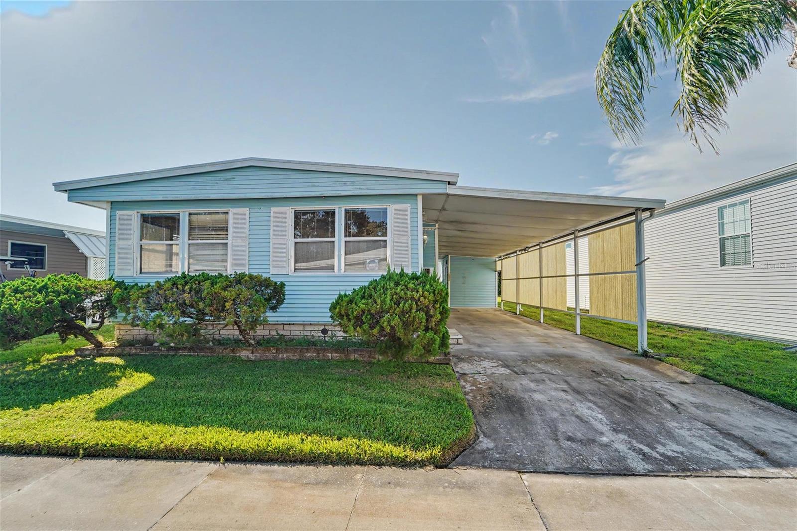 AFFORDABLE LIVING IN DUNEDIN, FLORIDA! Just $275 Monthly HOA Fee in this Sought-After 55 Plus Active Community!                                   The $275 maintenance covers Water, Sewer, Trash picked up at your door, and lawn service! Community HEATED POOL, INDOOR SHUFFLEBOARD, Spacious Clubhouse with ACTIVITIES GALORE, including BINGO, dances, Tai Chi, water aerobics!  Enjoy the benefits of this 100% resident owned CO-OP community where residents have a voice in the community management and decisions! NOT A LANDLEASE. NOT IN A FLOOD ZONE. GREAT FOR WINTER GETAWAY! Baseball fans will love the location just down the street from the TORONTO BLUE JAYS' spring training ballpark.   This 2-BEDROOM, 2 FULL BATHS mobile home offers 1008 sq ft of Heated living space, PLUS a large Florida Room and a storage shed bring the total area to 1852 sq ft.  PLUS a COVERED CARPORT and STORAGE SHED that houses the WASHER/DRYER, utility sink, workbench, 2021 Water heater, and storage shelves!  AC NEW IN 2023!     The Price reflects the need for Repair and Updating! Immediately needs new flooring and subfloor, but it's your chance to do it your way, your style, and be in this fabulous community! Because this is an Estate sale, this is being Sold AS IS.