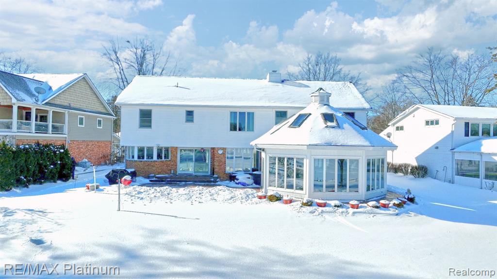 Spring is right around the corner. This stunning two-story home has been tastefully updated & meticulously maintained, and is nestled within the highly sought-after Keatington Subdivision. Offering 102 feet of prime frontage on private, all-sports Voorheis Lake, the setting is nothing short of spectacular.  The 250-acre lake is renowned for its crystal-clear water, impressive depth of approximately 70 feet with exceptional community amenities, including a private beach & boat launch. This is lake living at its finest—where every day feels like a vacation. Inside, the home is warm, inviting, and designed for both comfort & entertaining. The gourmet kitchen is a chef’s delight, opening to a spacious great rm & dining rm anchored by a stunning three-sided fireplace. An all-seasons room featuring a hot tub, stone floor and shower provides year-round enjoyment and opens to a lakeside patio—perfect for al fresco dining and entertaining. From there, walk to the water’s edge, where a sandy beachfront awaits and private dock for your boat. All bedrooms are located on the upper level and are generously sized. The primary suite is truly exceptional, featuring a private sitting rm, a luxurious spa-like bath, an impressive walk-in closet, and a grand bedroom featuring a cathedral ceiling and windows overlooking the lake, offering spectacular sunrise views. Additional highlights include a heated three-car garage w/3rd bay currently being used as a workshop, a full basement with a family room/recreation rm, a half bath & plenty of storage. Other note worthy mentions include breathtaking lake views from most windows t/o the home. Multiple Furnace and A/C units, all upstairs windows tilt in for easy cleaning and many updates (see the update list in documents) This is a rare chance to own an extraordinary lakefront property—Seller is ready to let a lucky buyer start making memories in the fabulous lakefront home.