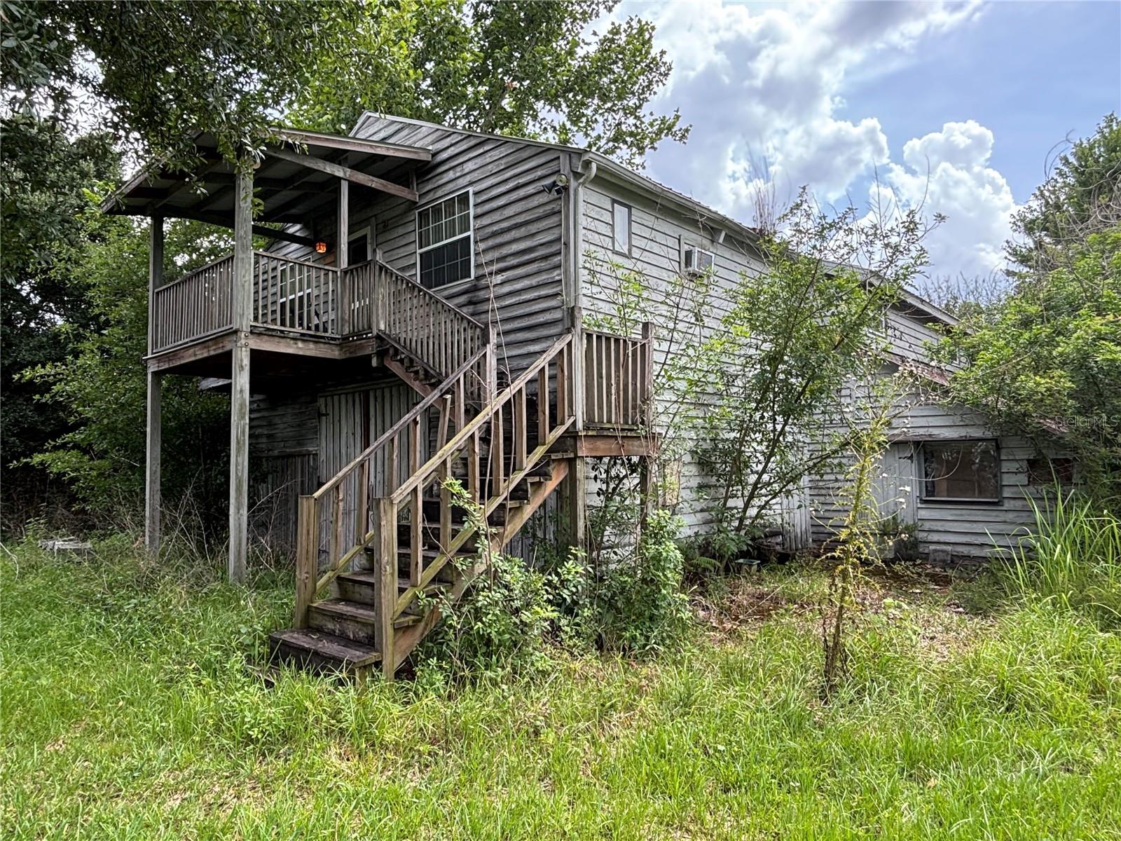 AMAZING OPPORTUNITY to own your own private slice of country paradise while remaining just minutes from shopping, dining, major roadways, and everyday conveniences! This exceptional nearly 5-acre property offers the perfect blend of peaceful rural living and modern accessibility.  Whether you're an equestrian, hobby farmer, or simply looking for room to spread out, this property is ready to accommodate your dreams. Bring the horses, establish a livestock farm, create a homestead, or simply enjoy the privacy and serenity of beautifully maintained pastureland framed by picturesque tree-lined views.  The barn is designed with both functionality and future potential in mind. The ground level features multiple horse stalls, a tack room, feed room, wash stall, and ample space for equipment, storage, or additional agricultural uses. Whether you're operating a working farm or pursuing recreational equestrian activities, you'll appreciate the thoughtful layout and versatility.  Above the barn is a charming and well-appointed 3-bedroom, 1-bath residence offering comfortable living with peaceful views of the surrounding countryside. In addition, there is an abundance of unfinished space that provides endless possibilities for expansion—create additional bedrooms and bathrooms, a larger owner's suite, guest quarters, a home office, entertainment space, or simply enjoy the extra storage.  With nearly five acres of land, countless possibilities for customization, and an unbeatable location that offers the tranquility of country living without sacrificing convenience, this is a truly rare opportunity. Bring your imagination and discover the lifestyle you've always dreamed of. Schedule your private showing today and experience everything this remarkable property has to offer!