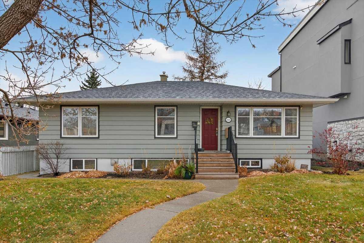 Opportunity Awaits! Situated on a desirable tree-lined street in the community of Killarney - one of Calgary's most vibrant and evolving inner-city neighbourhoods - this impressive property offers exceptional versatility. Ideal for families seeking space and comfort or buyers looking to secure a lot with future redevelopment potential. This well-cared-for, single-family detached home offers 1,256 sq. ft. on the main level. A bright foyer with French doors opens to the spacious living and formal dining area. Original hardwood floors add to the warmth and character. The main floor features three generous bedrooms and an updated bathroom. The thoughtfully designed kitchen showcases attractive cabinetry, quartz countertops, convenient pull-outs, and a cozy breakfast nook overlooking the private, fully fenced backyard. Mature landscaping creates a peaceful outdoor retreat, highlighted by a beautiful Larch tree that turns a stunning golden color each fall. The fully developed basement expands your living space - ideal for multigenerational living or a home office setup. It includes three additional bedrooms, a full bathroom, a comfortable family room with a freestanding gas fireplace (remote controlled), a second Kitchen, and ample storage throughout. Numerous updates over the years include all-weather windows, custom blinds, shingles (2015), and a double detached garage (built 2018 with permit). Enjoy the unbeatable convenience of Killarney - just minutes to downtown, close to schools, parks, shopping, transit, and major roadways. Move in and enjoy, invest and hold, or plan for future development - this property offers immediate livability and long-term potential in one of Calgary's most desirable inner-city communities.  An excellent opportunity!
