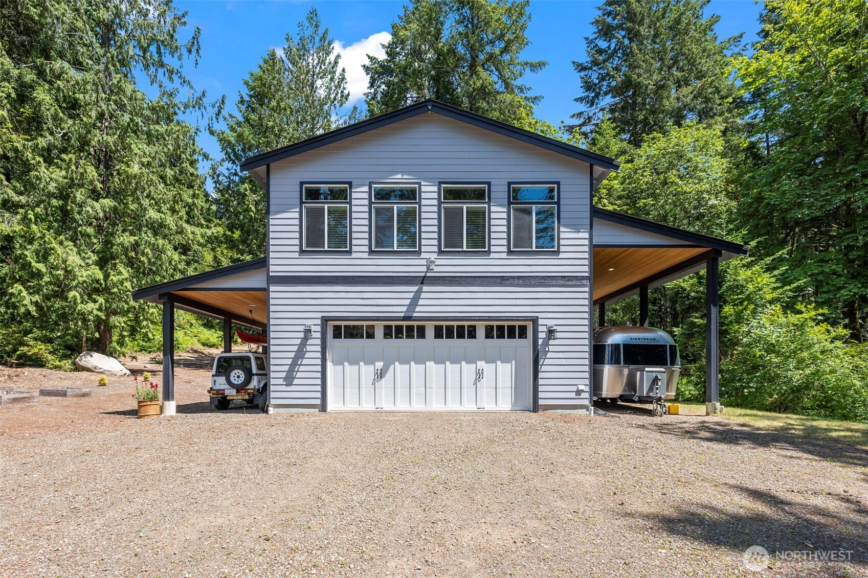 BARNDOMINIUM with huge potential on 2+ acres with 89 feet of waterfront! Live on the property while you build your dream home! Trim your trees for more view! Built in 2019 & move-in ready! The garage has ample room for cars, toys & shop space, plus laundry & 1/2 bath. Upstairs is a 1 bedroom apartment with the comforts of a heat pump, luxury vinyl plank flooring throughout, & a wall of windows facing the water providing great natural light. Kitchen has stainless steel appliances, subway tile backsplash & enviable walk-in pantry! Bedroom has adjoining full bath & walk-in closet. There are 2 additional carport areas outside. Plus property has 5 bedroom septic, RV hookup, and space for gardening or chickens, with no HOA! Best of all worlds!