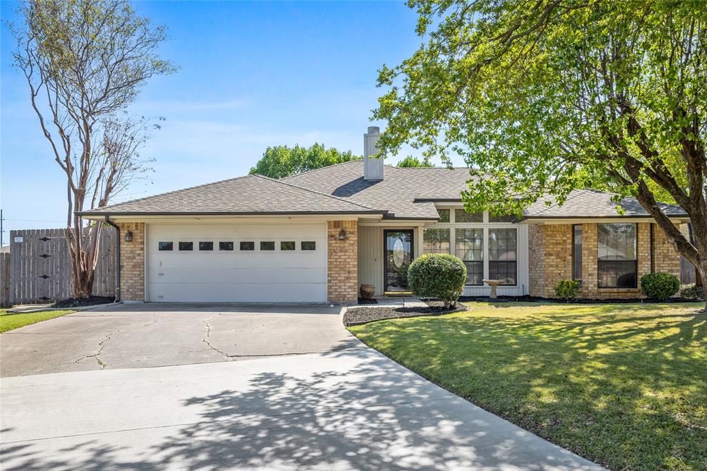 Tucked at the center of a quiet cul-de-sac in Trophy Club, this move-in ready home stands out with a backyard designed for relaxing, entertaining, and everyday escape, featuring mature trees, a spacious wood deck, and peaceful surroundings, all within walking distance to Lakeview Elementary.Welcome to 5 Sundance Court, where comfort meets everyday convenience and a truly standout outdoor space. Freshly painted with upgraded wood-simulated flooring throughout and no carpet, this home offers a clean, modern feel from the moment you walk in. The living area features a cozy brick fireplace with raised hearth and flows easily into the dining space and kitchen, where you will find granite countertops, stainless steel appliances, built-in cabinetry, dual sinks, and an eat-in area filled with natural light. The layout is functional and well-designed, offering privacy and flexibility for a variety of lifestyles. Step outside and discover a backyard where dreams are made, oversized with mature trees, a spacious wood deck, and plenty of room to relax, entertain, or simply enjoy peaceful birdwatching mornings. The fenced yard adds both privacy and usability, making it ideal for outdoor living. Additional features include a 2-car attached garage, sprinkler system, and a well-maintained lot in an established neighborhood. Located within Northwest ISD and walking distance to Lakeview Elementary, with easy access to parks, trails, golf, and Highway 114, this 3-bed home in Trophy Club offers a rare combination of location, updates, and outdoor space with no HOA.