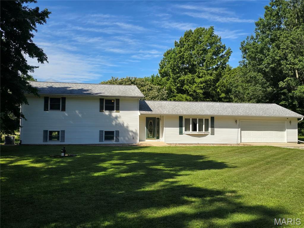Welcome to your peaceful retreat nestled on 2.54 acres of serene countryside just minutes from town! This spacious split-level home offers 4 bedrooms and 2.5 baths with room to roam both inside and out. Surrounded by mature shade trees, the backyard is a private haven perfect for entertaining or unwinding on the large deck.
For those who appreciate versatility, enjoy both an attached and detached garage—ideal for vehicles, hobbies, or extra storage. Whether you're sipping coffee in the shade or hosting friends, this property blends the best of country living with convenience to town amenities.
Recent updates include a 2021 roof, 2020 furnace, 2009 AC, and 2011 windows. Upgraded appliances include the oven and cooktop (2019), refrigerator (2020), and dishwasher (2020).   EJ Water can be hooked up for $600.