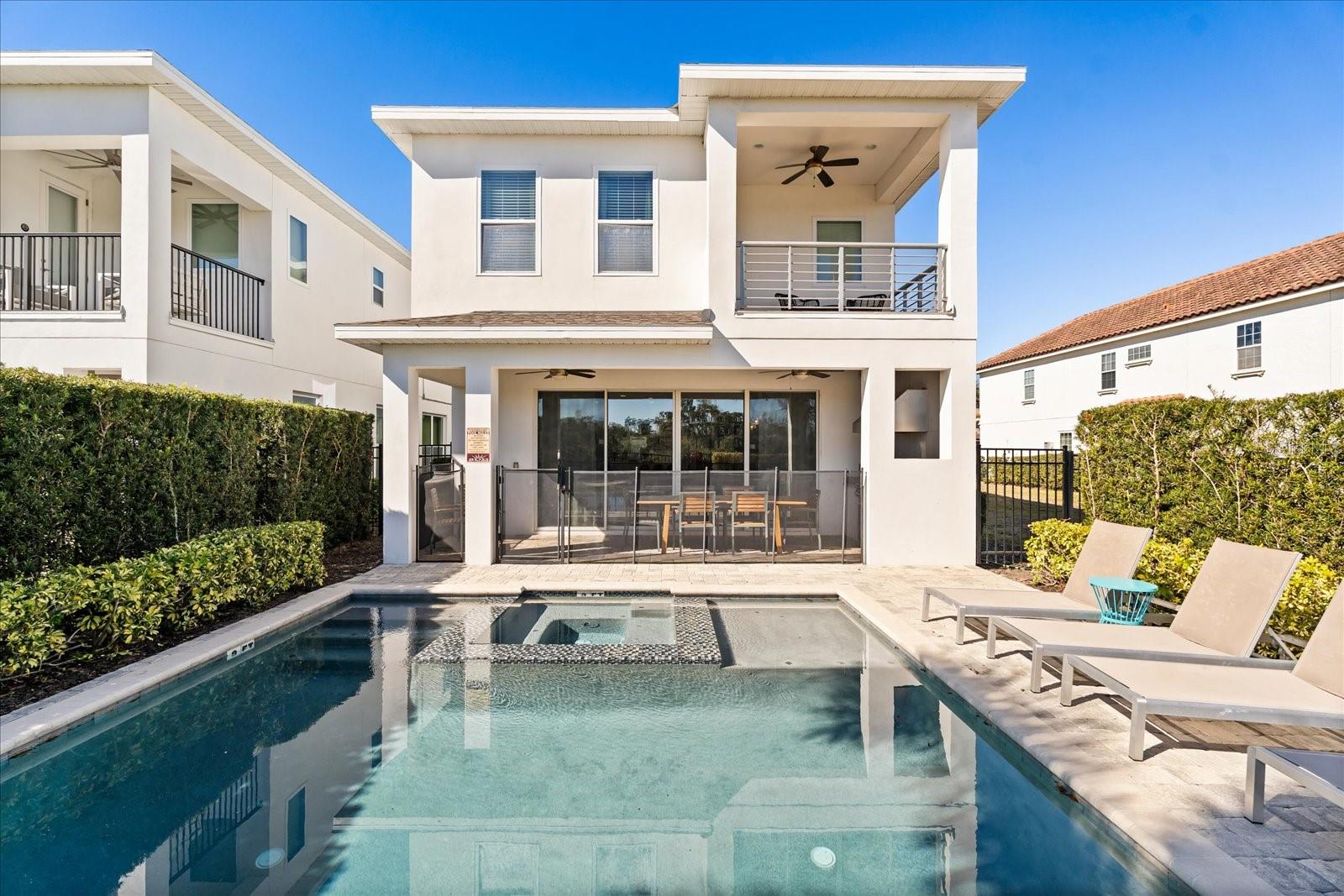 RESORT MEMBERSHIP AVAILABLE: The best priced 6 bedrooms on the market with adjacent lot available for purchase. Amazing opportunity to own a fantastic 6 bedroom home in Reunion Resort. This home is heavily used by homeowner.  Impeccably styled and thoughtfully designed, this stunning home offers the perfect blend of luxury, comfort, and resort-style living. The open-concept first floor creates an ideal setting for both everyday living and entertaining, seamlessly connecting the spacious living room and gourmet kitchen so everyone can gather while meals are prepared. The living area is bright and inviting, featuring a soothing neutral color palette, an oversized sectional, multiple seating areas, and space designed to accommodate the whole family. The chef’s kitchen is equipped with stainless steel appliances, granite countertops, abundant cabinetry, and a generous breakfast bar with seating for six. Adjacent to the living space, the dining area offers a large table that comfortably seats eight—perfect for hosting family dinners or guests. The primary suite is conveniently located on the first floor with elegant finishes, and a spa-inspired en-suite bath featuring dual vanities, a soaking tub, and an oversized walk-in shower. Upstairs, you’ll find five additional bedroom suites, including one with a private balcony overlooking the golf course. Two themed bedrooms add a fun and unique touch, making this home especially appealing for families and guests. A spacious loft provides an additional gathering space with a large sectional and gaming setup, while the dedicated home theater delivers an immersive movie-night experience. Step outside to your own private pool deck, where serene golf course views create a peaceful backdrop for swimming, relaxing, or entertaining. The outdoor summer kitchen makes al fresco dining effortless—ideal for barbecues and evenings under the stars. Located within the prestigious, amenity-rich Reunion Resort, enjoy access to three world-class PGA Championship golf courses, multiple resort pools, a five-acre water park with a lazy river and slides, tennis and sports courts, a full fitness center, spa services, and a variety of on-site dining options. Whether used as a primary residence, second home, or luxury vacation rental, this exceptional property delivers the lifestyle and location buyers seek in one of Central Florida’s most desirable resort communities.