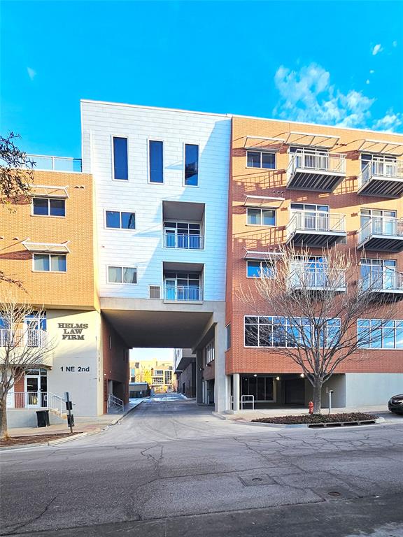 A rare opportunity to live at The Loft! This condo features warm wood flooring, oversized windows that fill the space with natural light, and wide city views. The kitchen connects directly to the living area and includes a large center island, granite countertops, stainless steel appliances, built-in microwave, and refrigerator. Both bedrooms include their own full bathrooms with white cabinetry, granite counters, tub/shower combinations, and walk-in closets. Exposed ductwork adds an urban industrial character throughout. Amenities include a clubhouse with gathering space and kitchen, along with a rooftop area that overlooks downtown Oklahoma City—perfect for time with friends. Two assigned parking spaces are located in the underground garage, and nearby street parking makes it easy for guests to visit. Water and trash service are provided. Located in the heart of downtown OKC, you’ll be just a short walk from dining, entertainment, and everything the city has to offer. Schedule your private showing today!